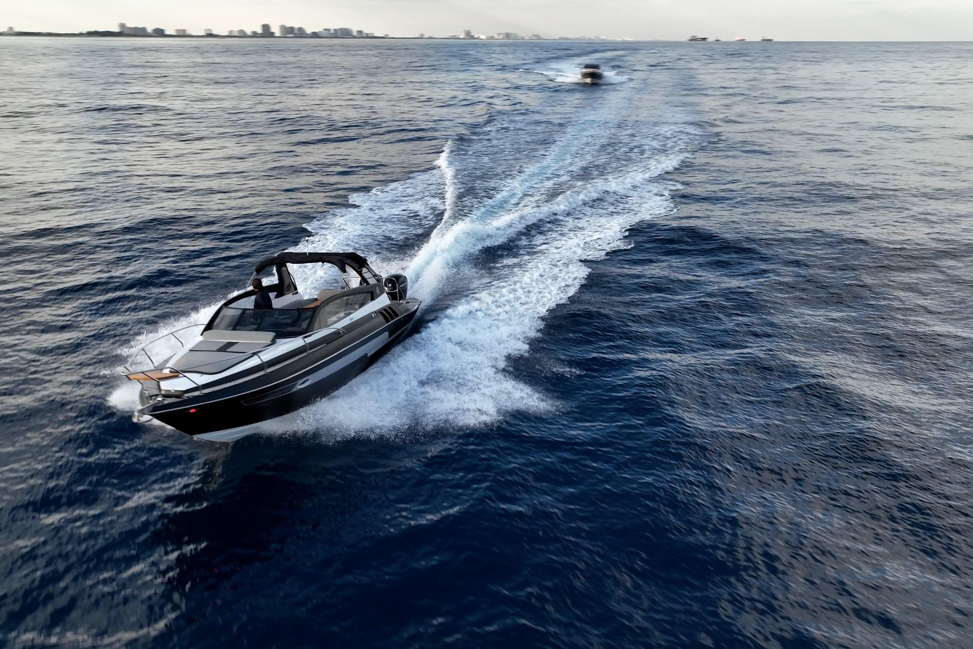 2027 Hanover 305 boat cruising on open water, leaving a wake behind.