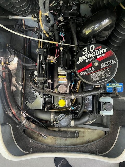 Engine compartment of a Bayliner 185 with a 3.0L MerCruiser engine.