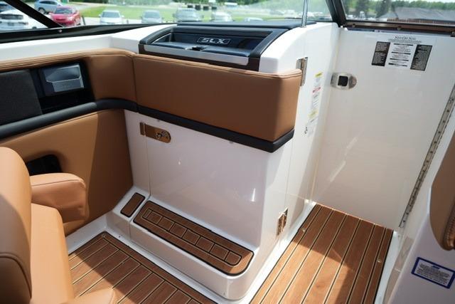 Interior of 2014 Sea Ray 270 SLX boat with brown leather seating and wood flooring.