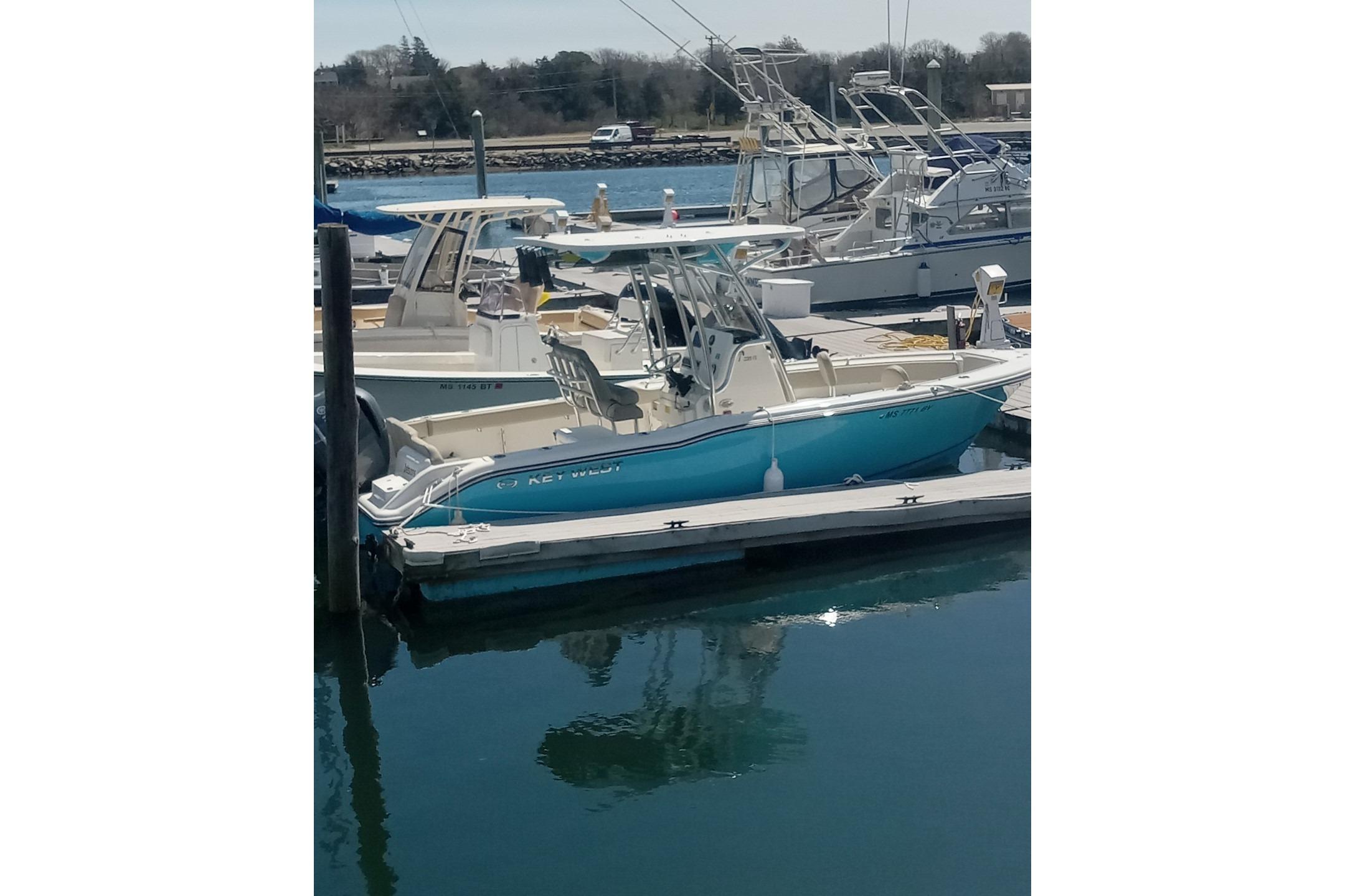 2024 Key West 239 FS boat docked in a marina, surrounded by other vessels.