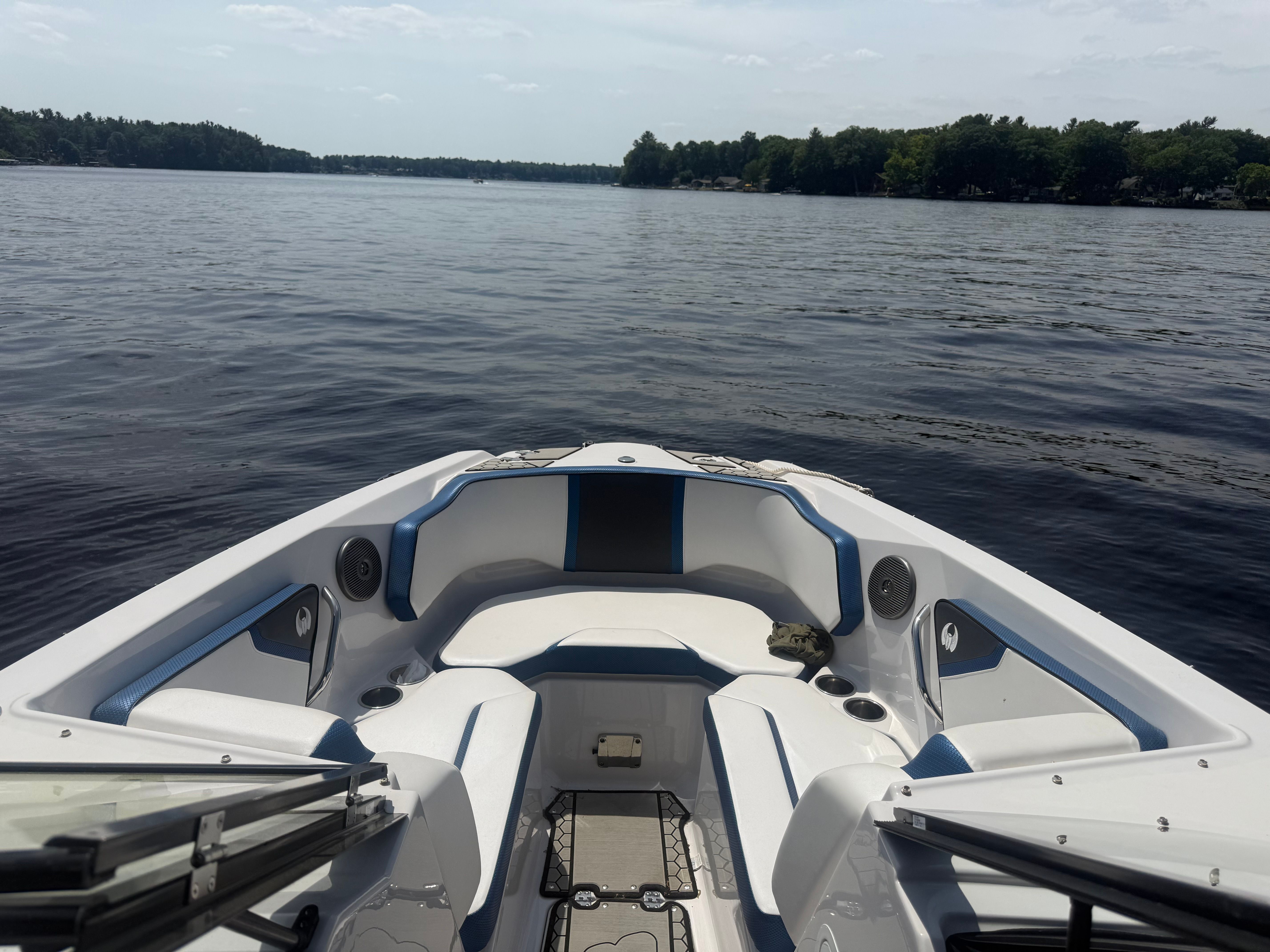 2018 Scarab 255 HOI on a calm lake with wooded shoreline.