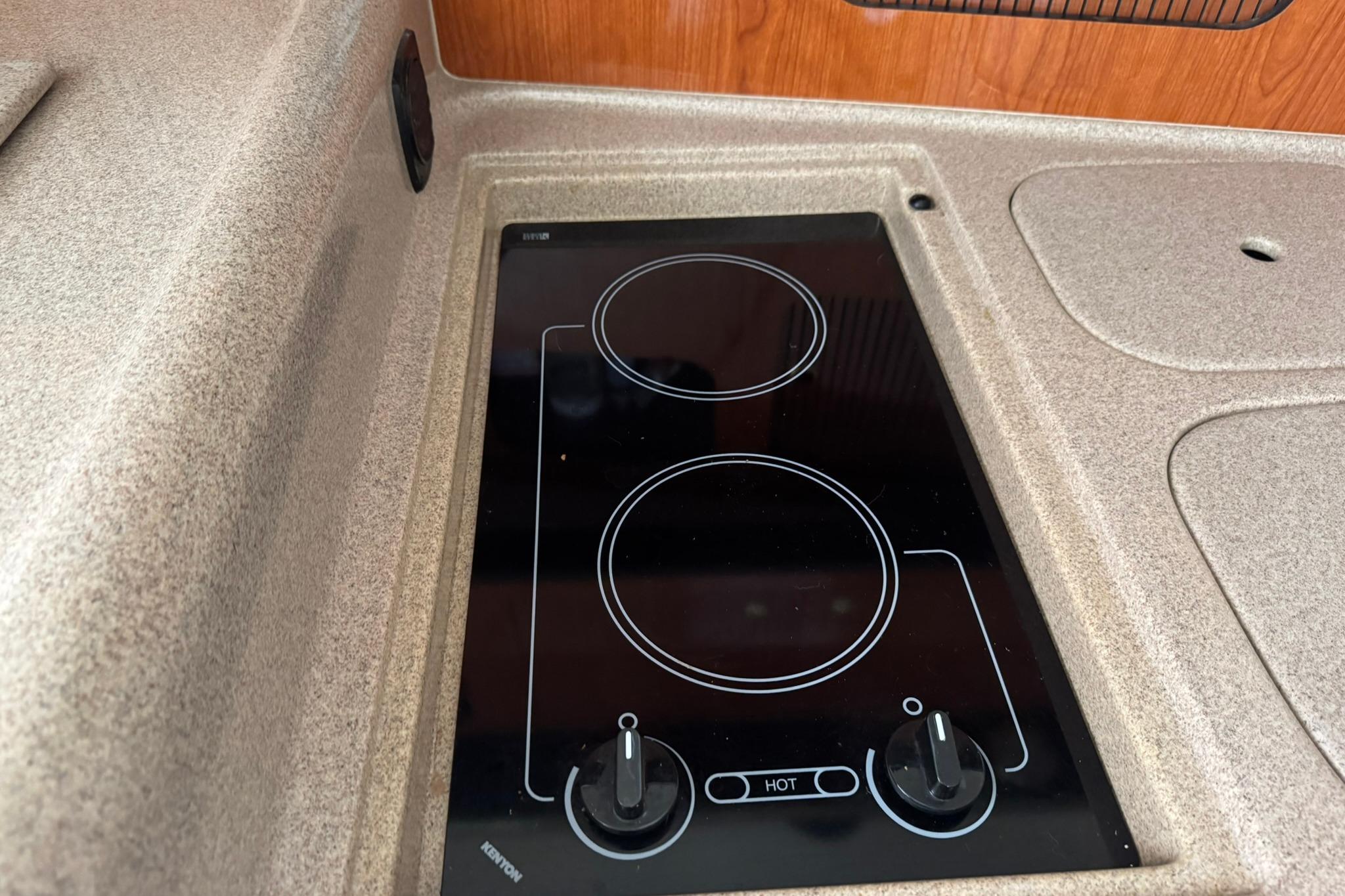 Built-in stovetop on 2001 Sea Ray 340 Sundancer yacht kitchen counter.