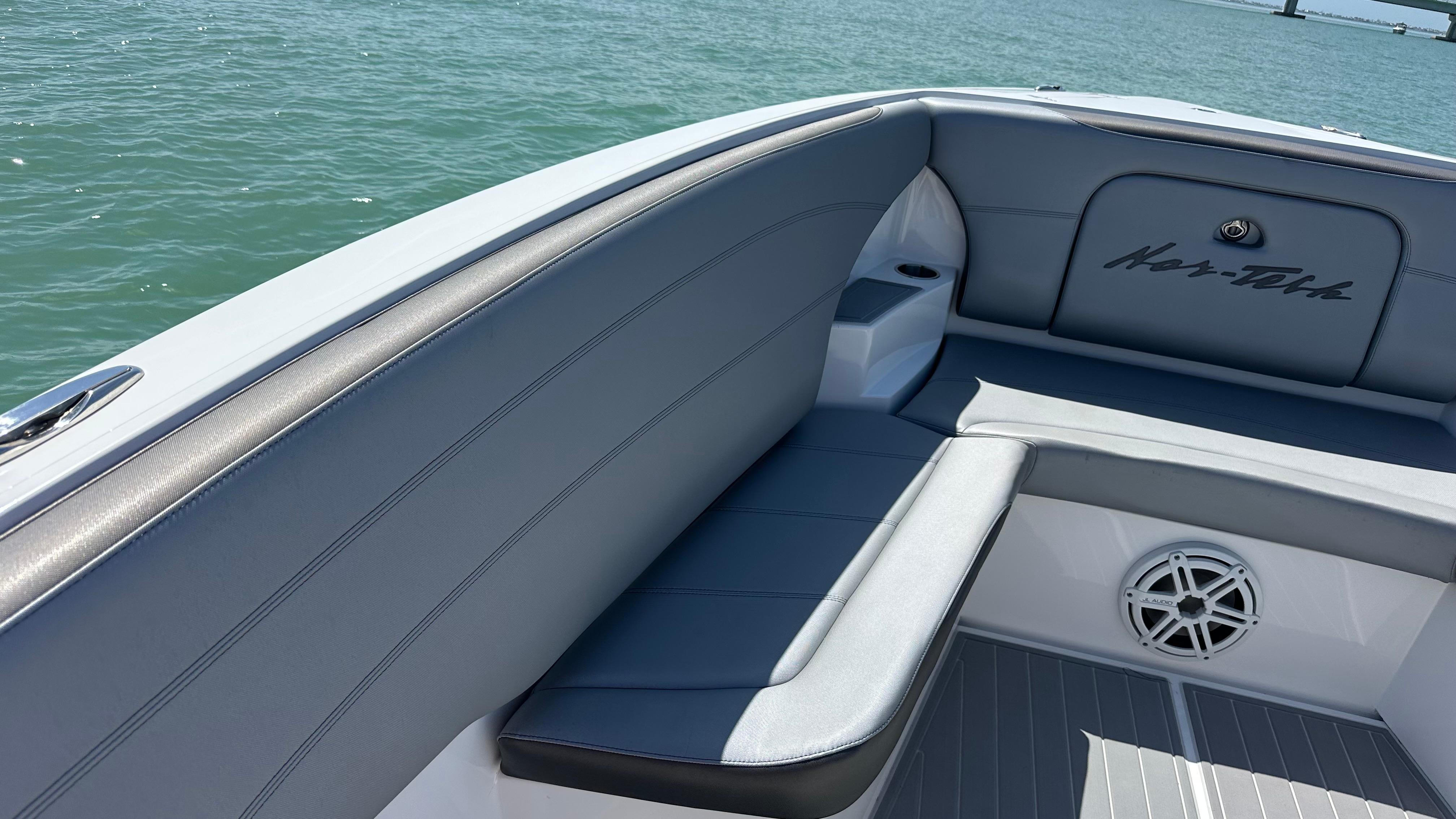 2018 Nor-Tech 340 Sport Center Console boat interior with gray seating and speaker.