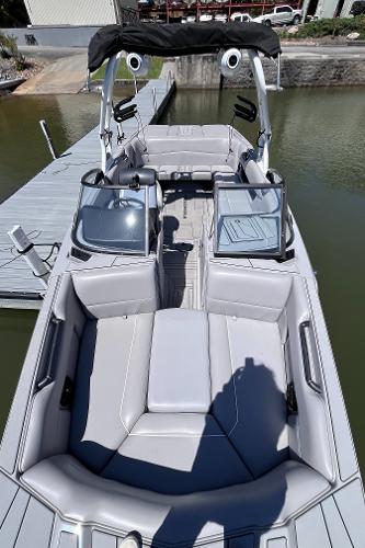 2024 Moomba Max boat with sleek gray interior, docked by the water.