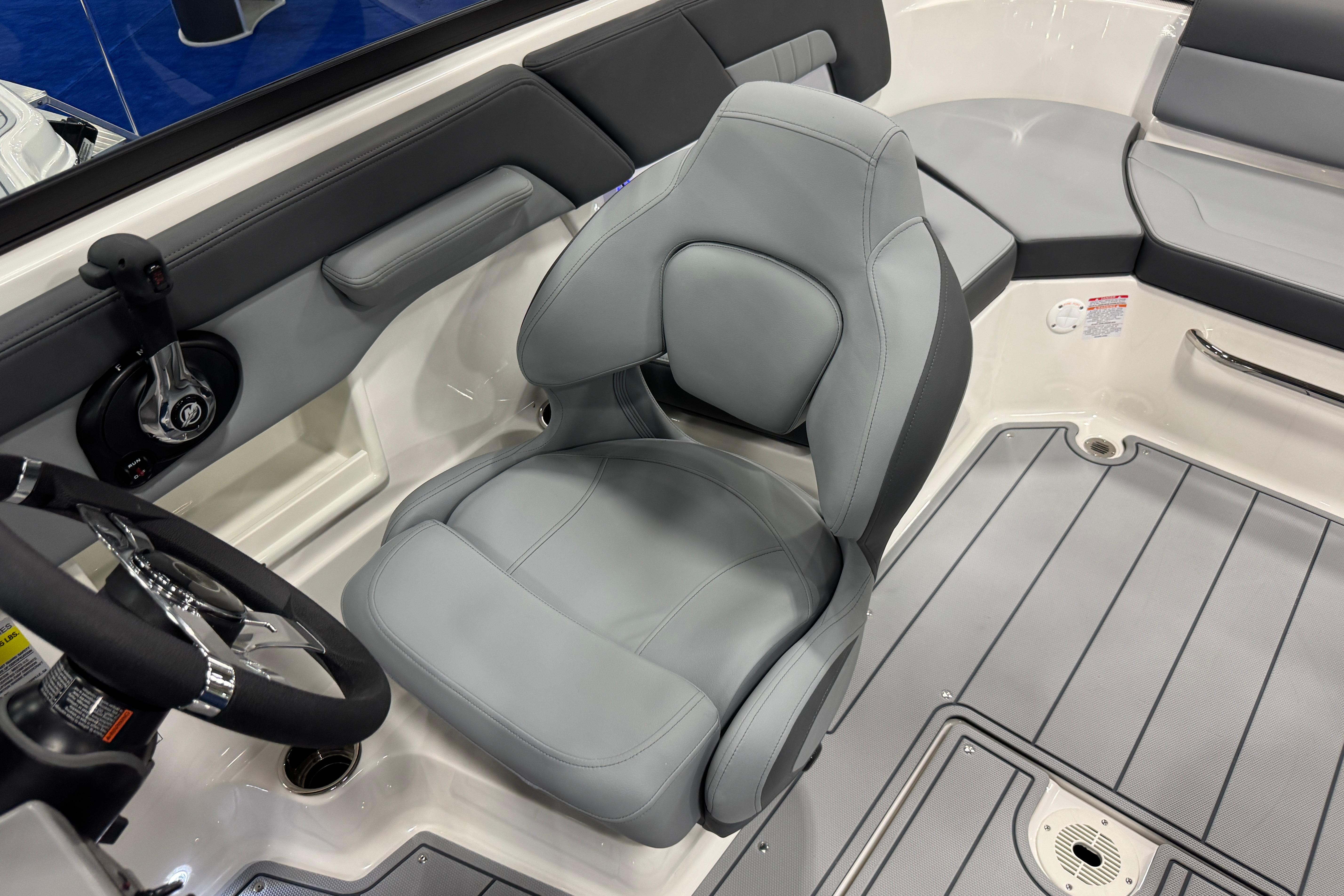 2026 Chaparral 23 SSi boat interior with gray seating and steering wheel.