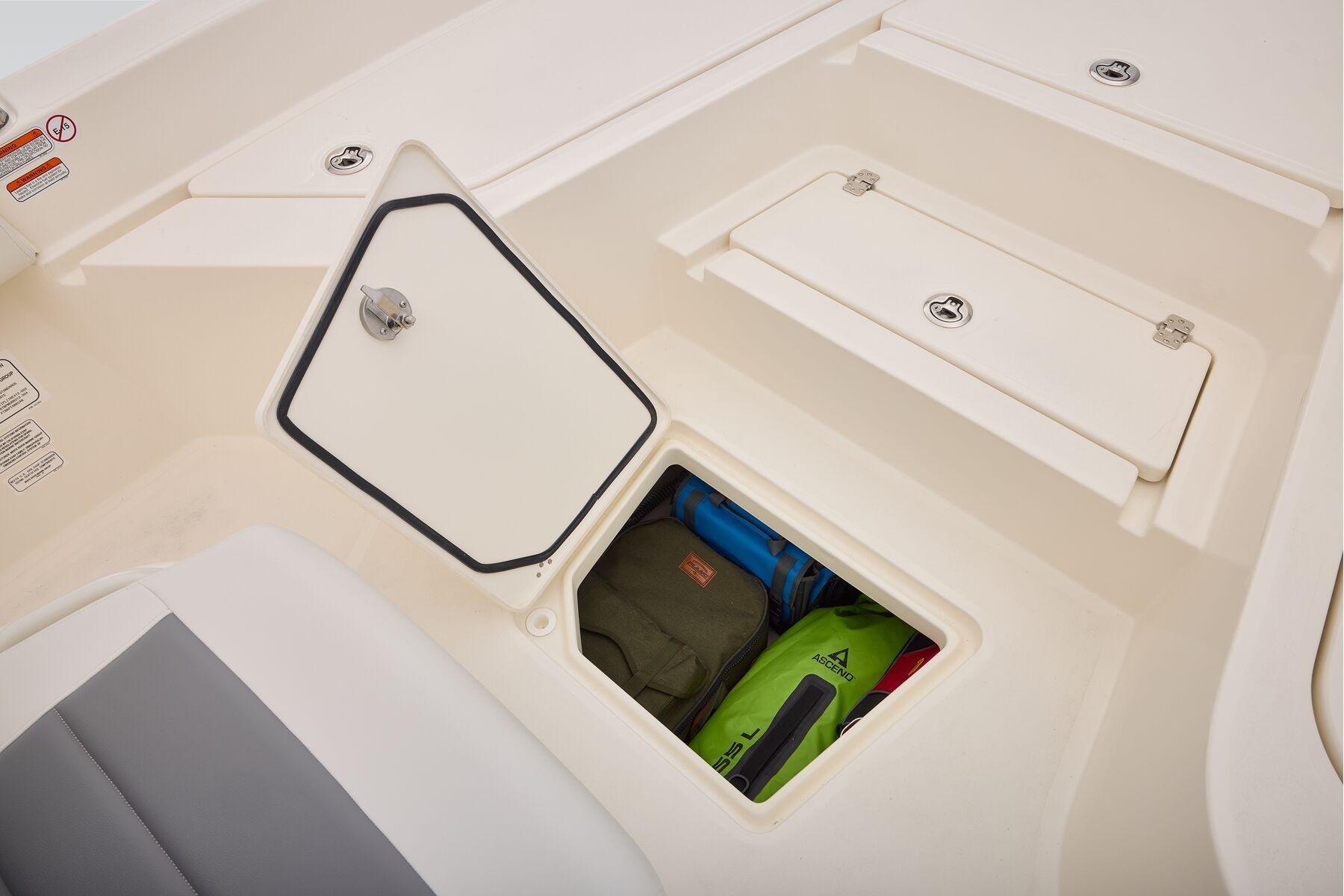 Storage compartment on 2026 Mako 24 APEX boat, featuring secure hatch and organized gear.