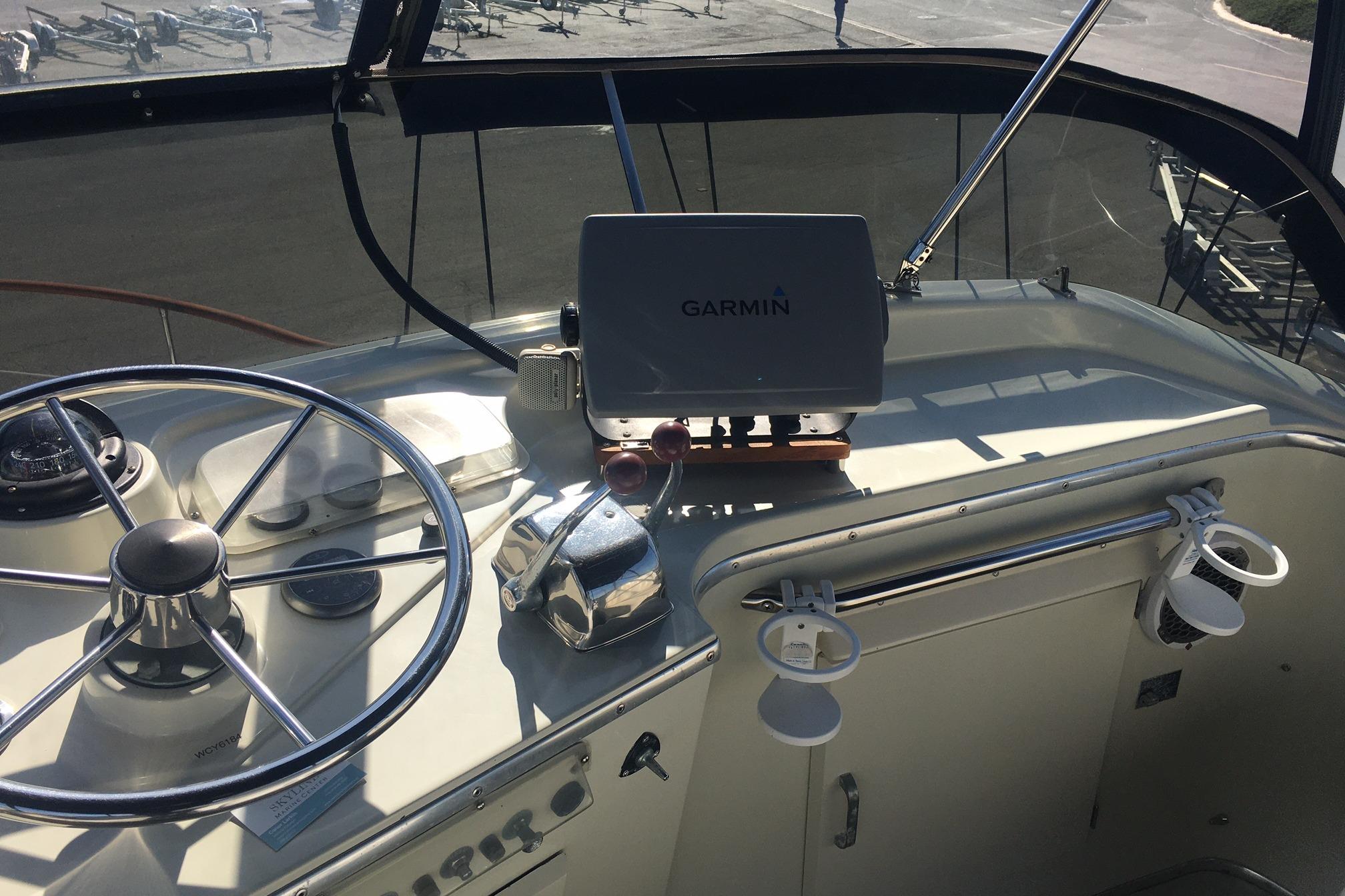 1978 Tollycraft 40 Tri-Cabin MY helm with Garmin navigation system and steering wheel.