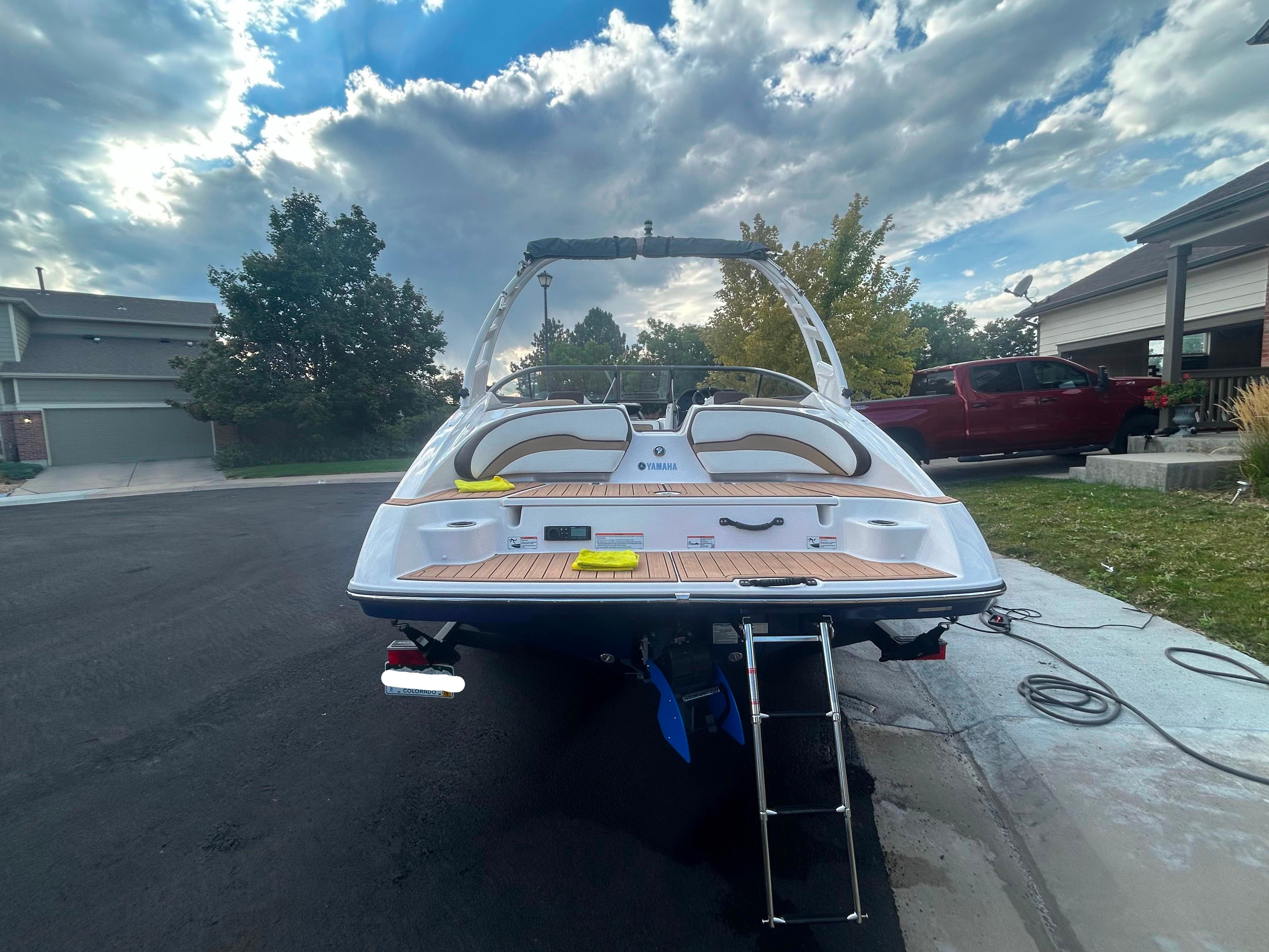 Rear view of a 2022 Yamaha Boats 195S on a driveway.