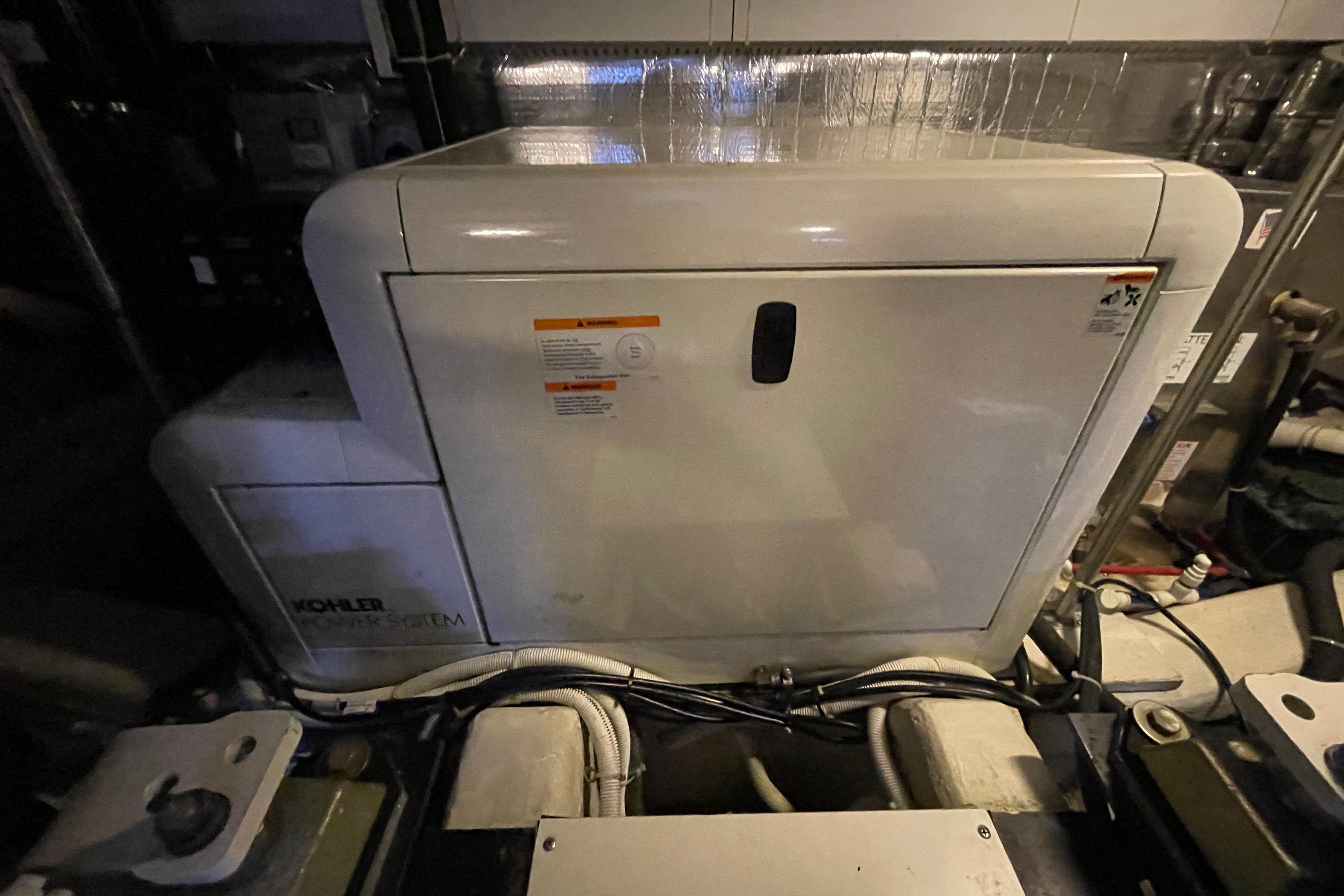 Engine room of 2002 Carver 570 Voyager Pilothouse with Kohler power system.