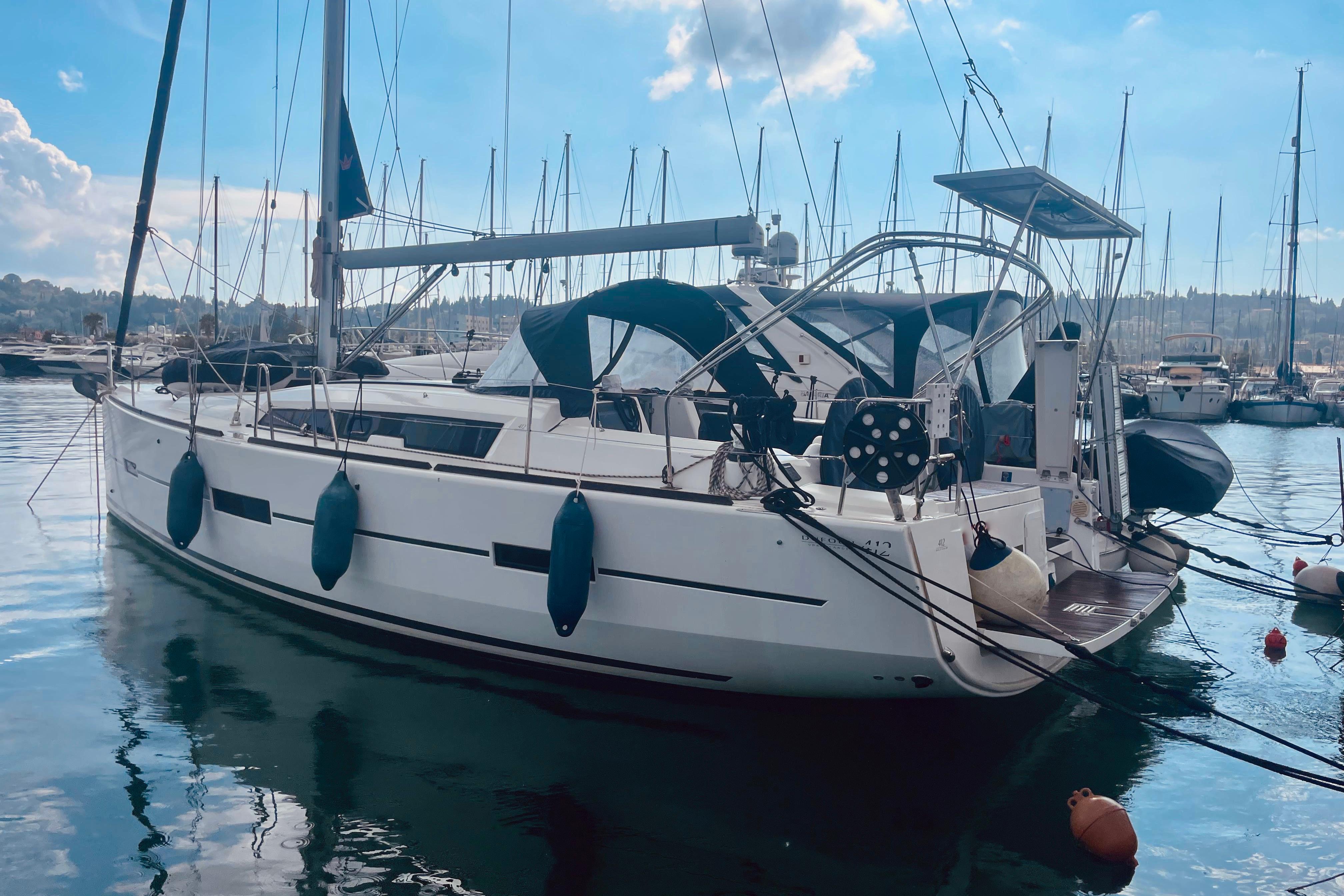 Sailboat Dufour 41.2 GL 2015 docked in marina, clear sky, calm water.