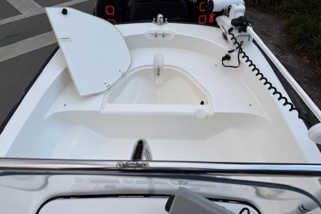 2016 Boston Whaler 150 Montauk boat interior with open storage compartment and trolling motor.