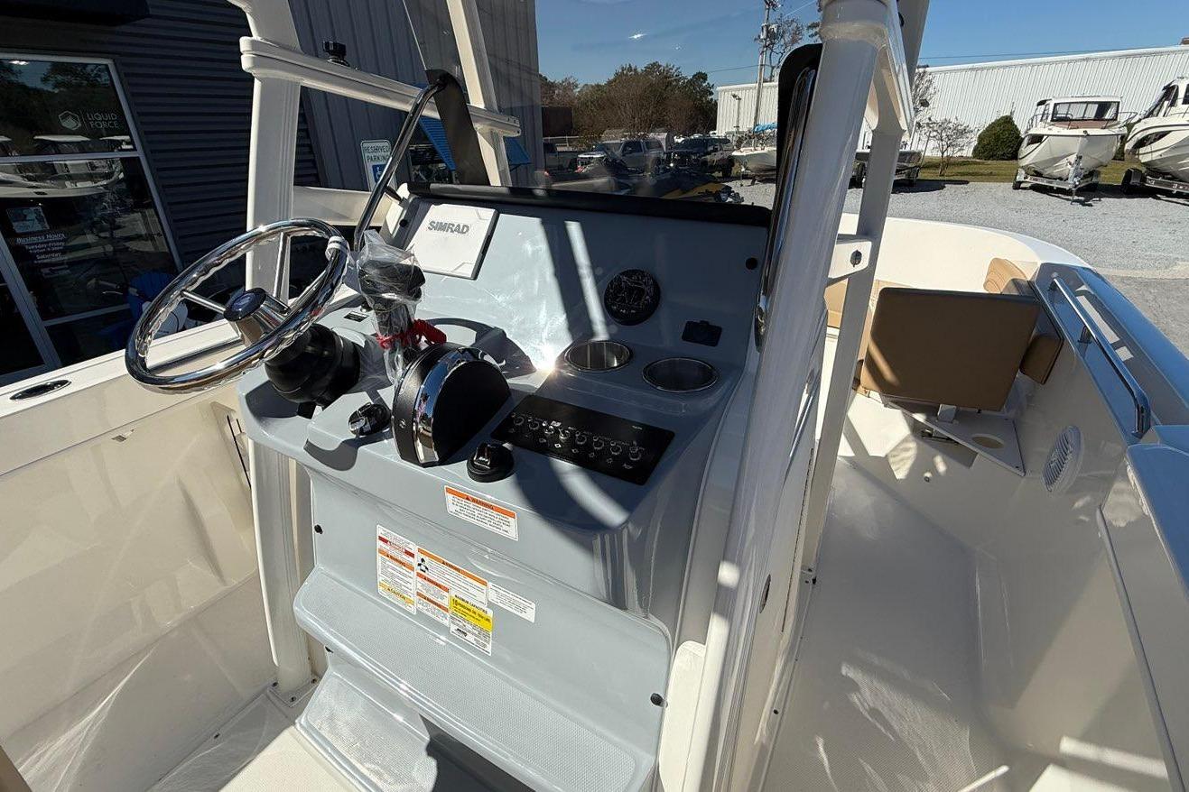 2026 Bayliner Trophy T22CC boat console with steering wheel and controls.