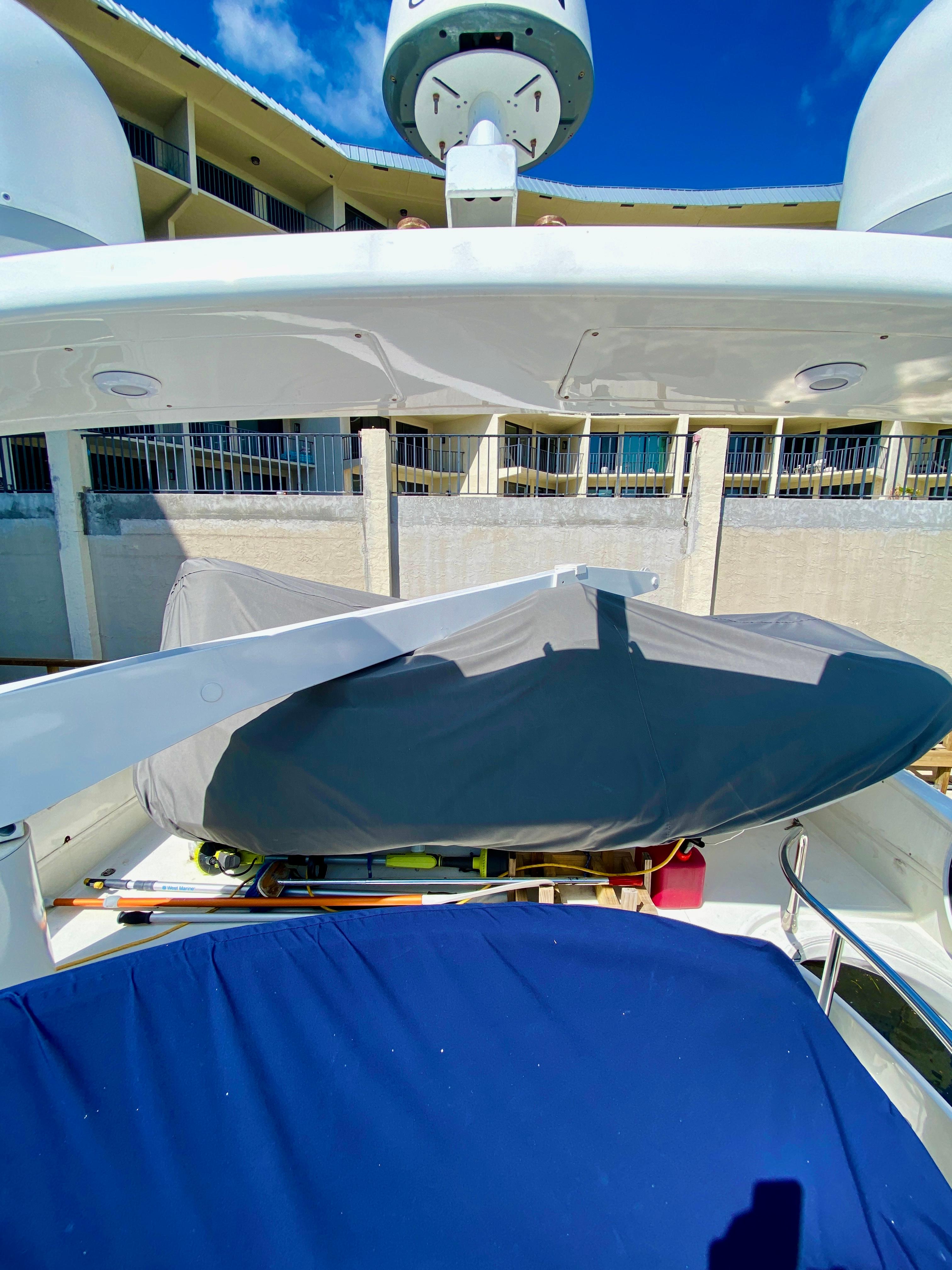 Azimut 55 yacht, 2002 model, deck view with covered equipment, sunny day.