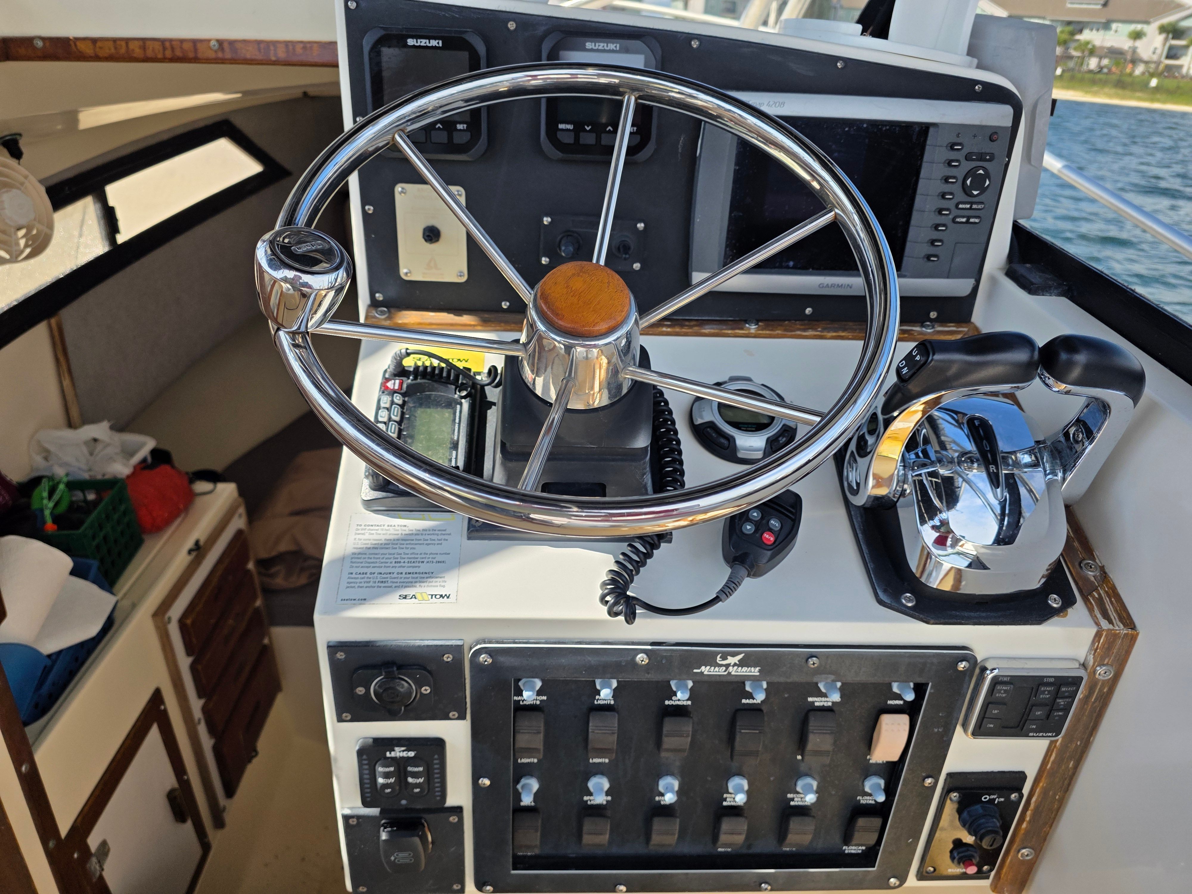 Helm of a 1987 Mako 248 WAC boat with navigation equipment.