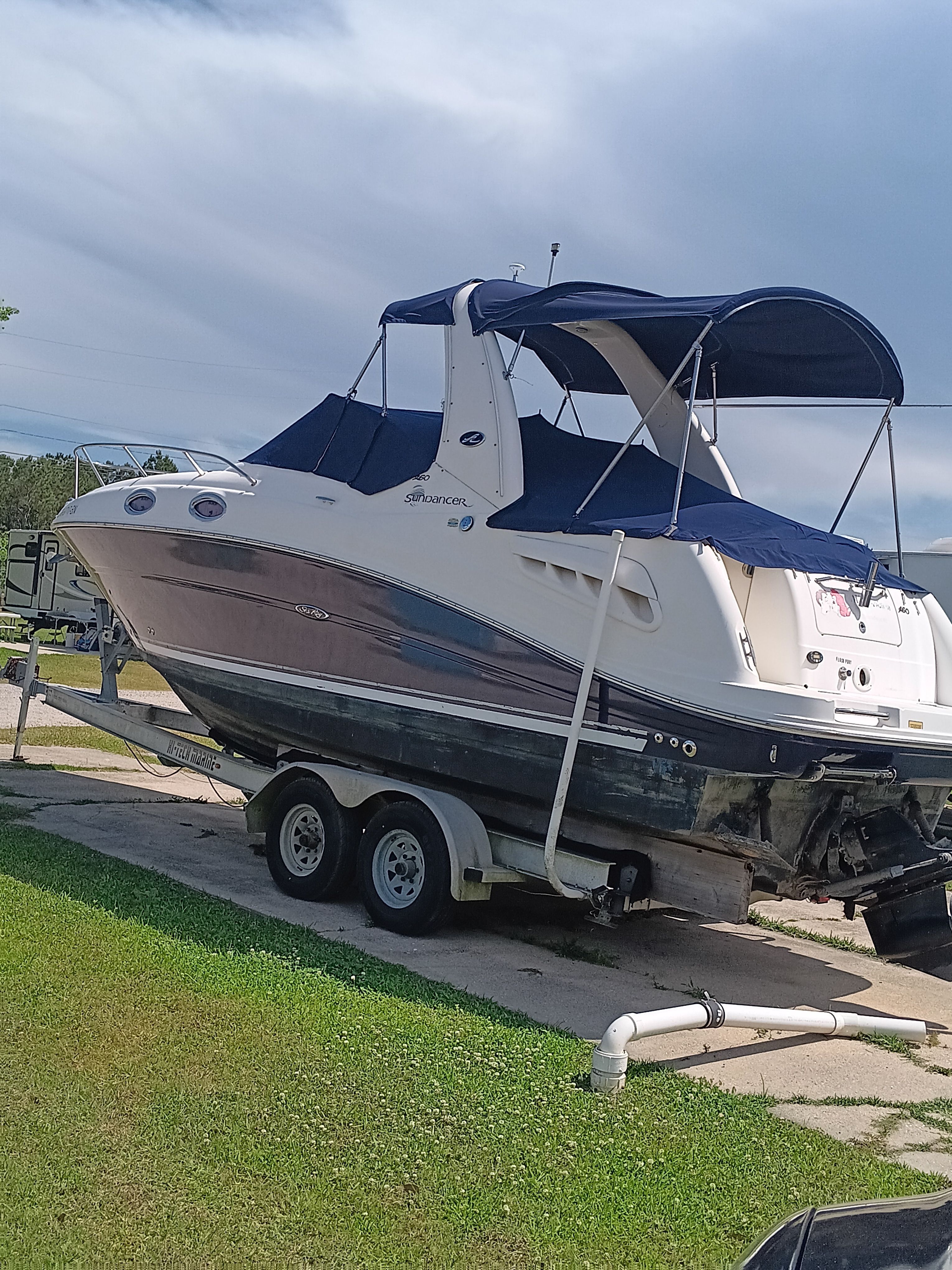 A 2005 Sea Ray 260 DA Sundancer on a trailer, featuring a blue canopy.