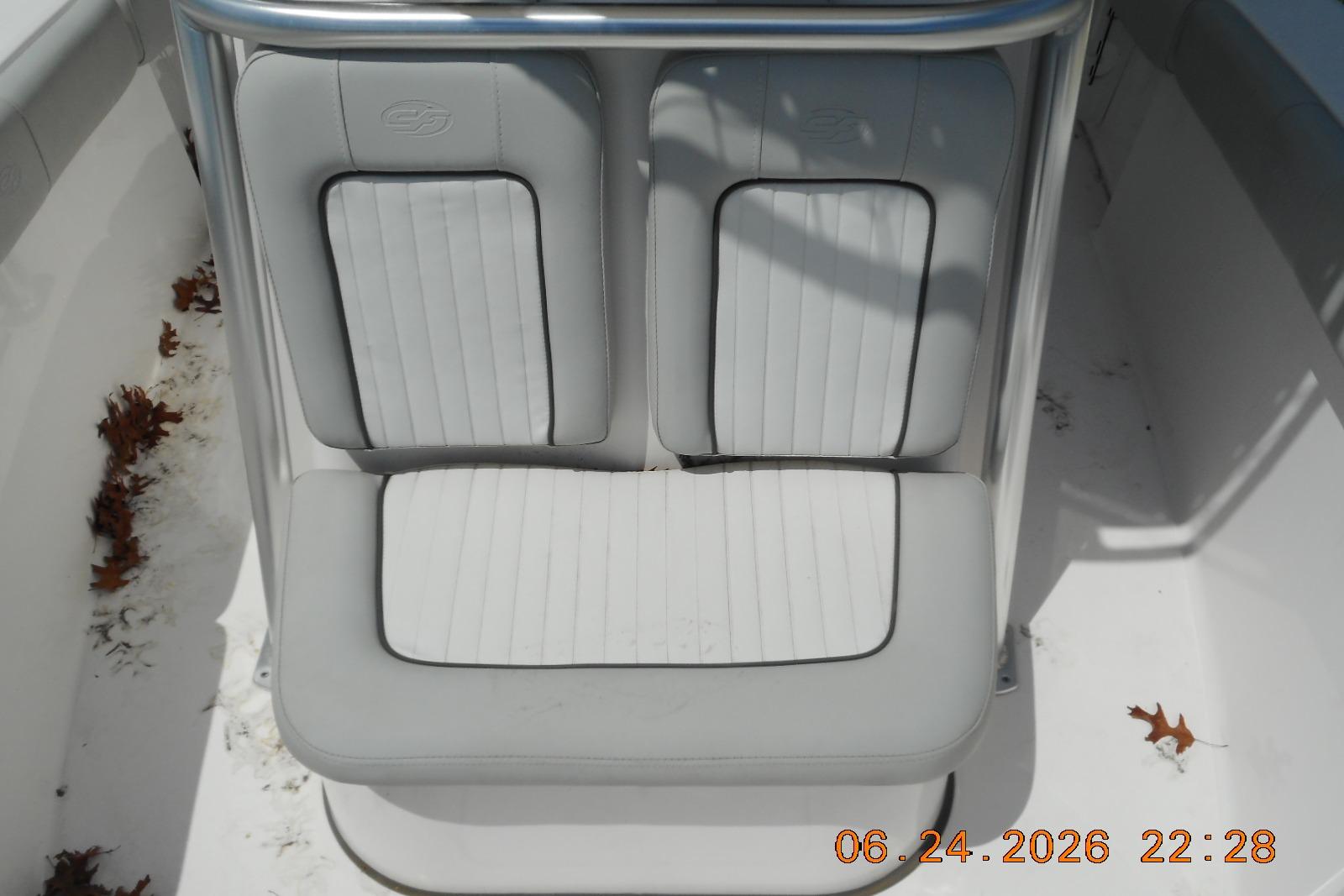 2022 Sea Fox 228 Commander boat seating with white cushions and metal frame.