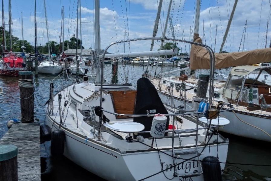 1981 Sabre 30 sailboat docked in a marina with other boats.