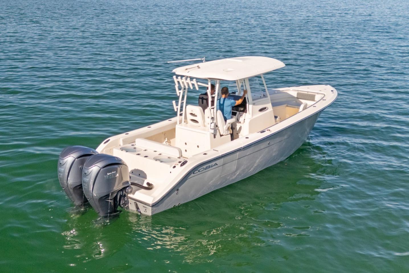 2023 Cobia 301 Center Console boat cruising on open water.