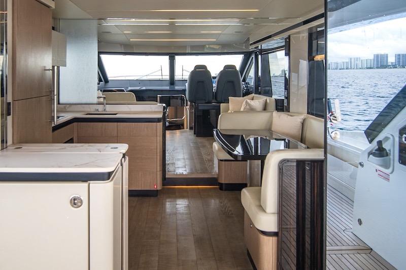 Luxurious interior of 2023 Absolute 62 Fly yacht with modern furnishings and panoramic windows.