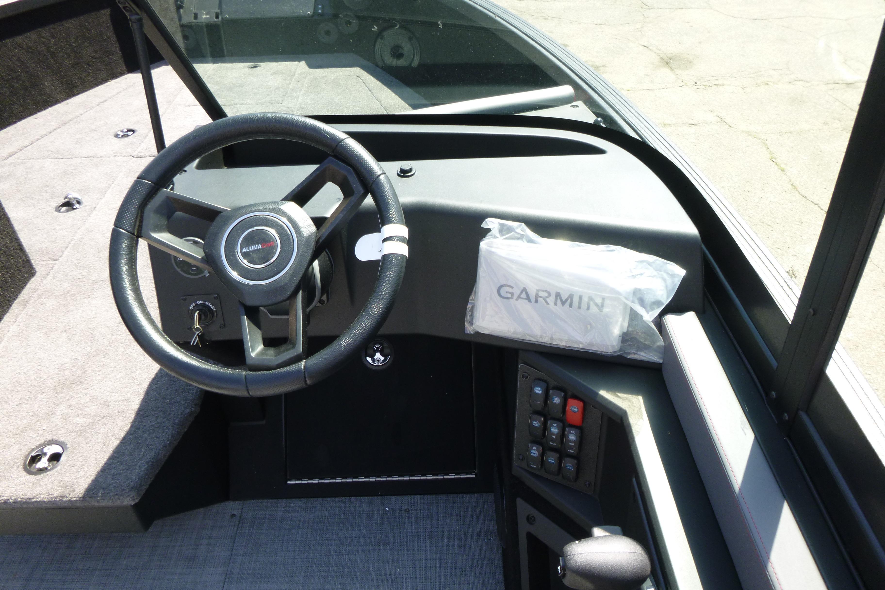 2025 Alumacraft Trophy 185X Sport dashboard with steering wheel and Garmin device.