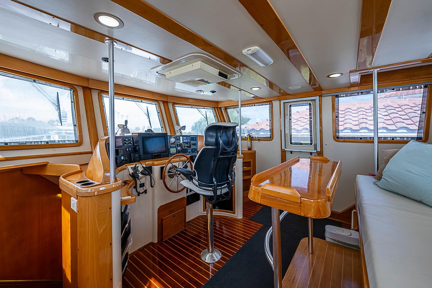 Interior of 2003 Magna Marine Nova Scotia 47, featuring helm, seating, and wooden accents.