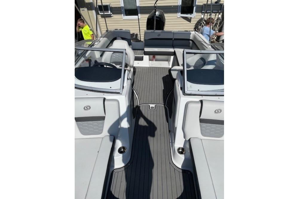 2023 Hurricane SunDeck 217 OB boat interior with seating and steering console.