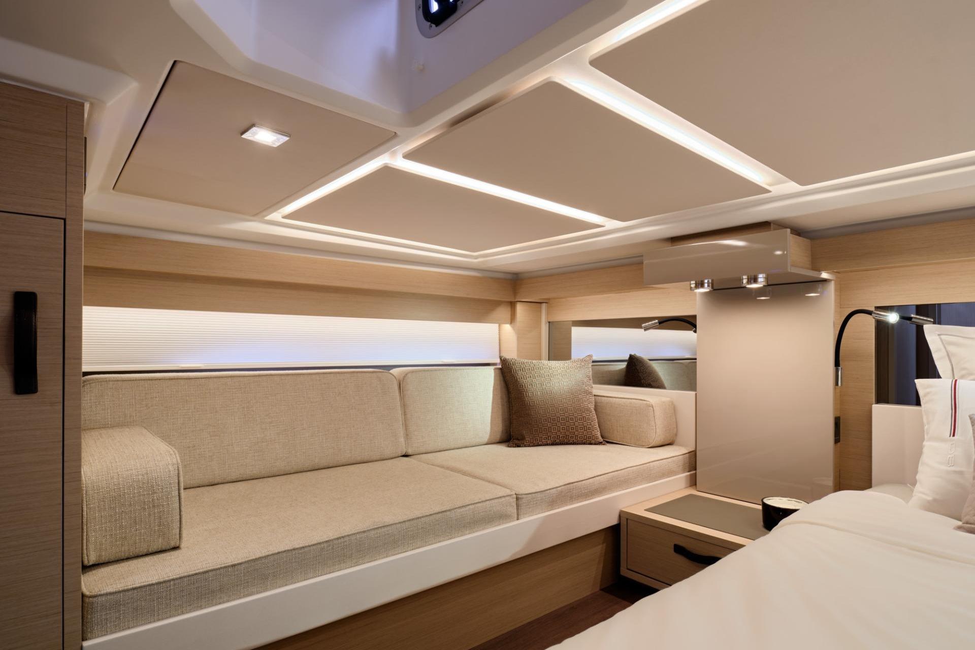 Luxurious interior of 2027 Jeanneau DB/43 OB yacht with modern seating and lighting.