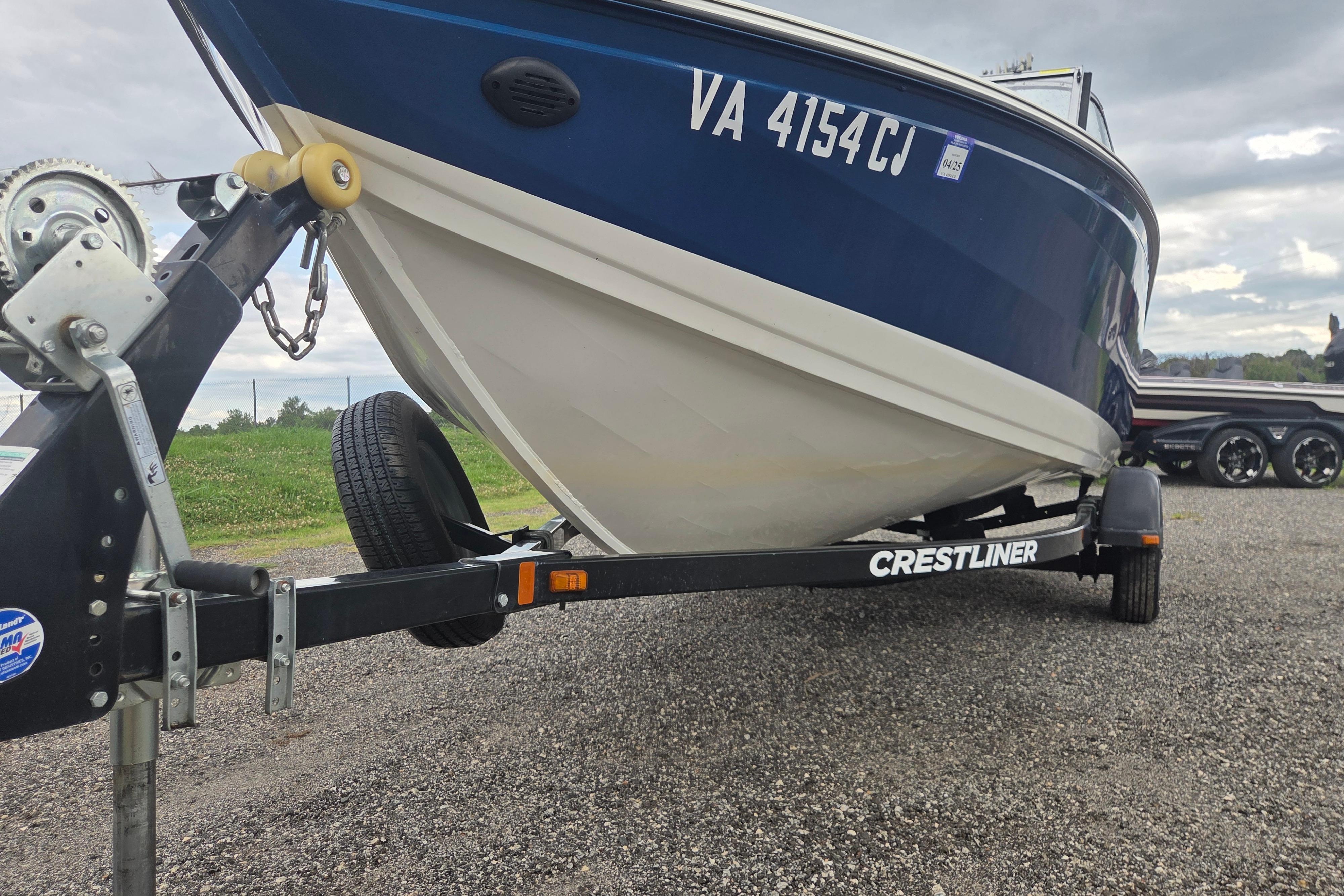 2016 Crestliner 1650 Fish Hawk SC boat on trailer, parked on gravel.