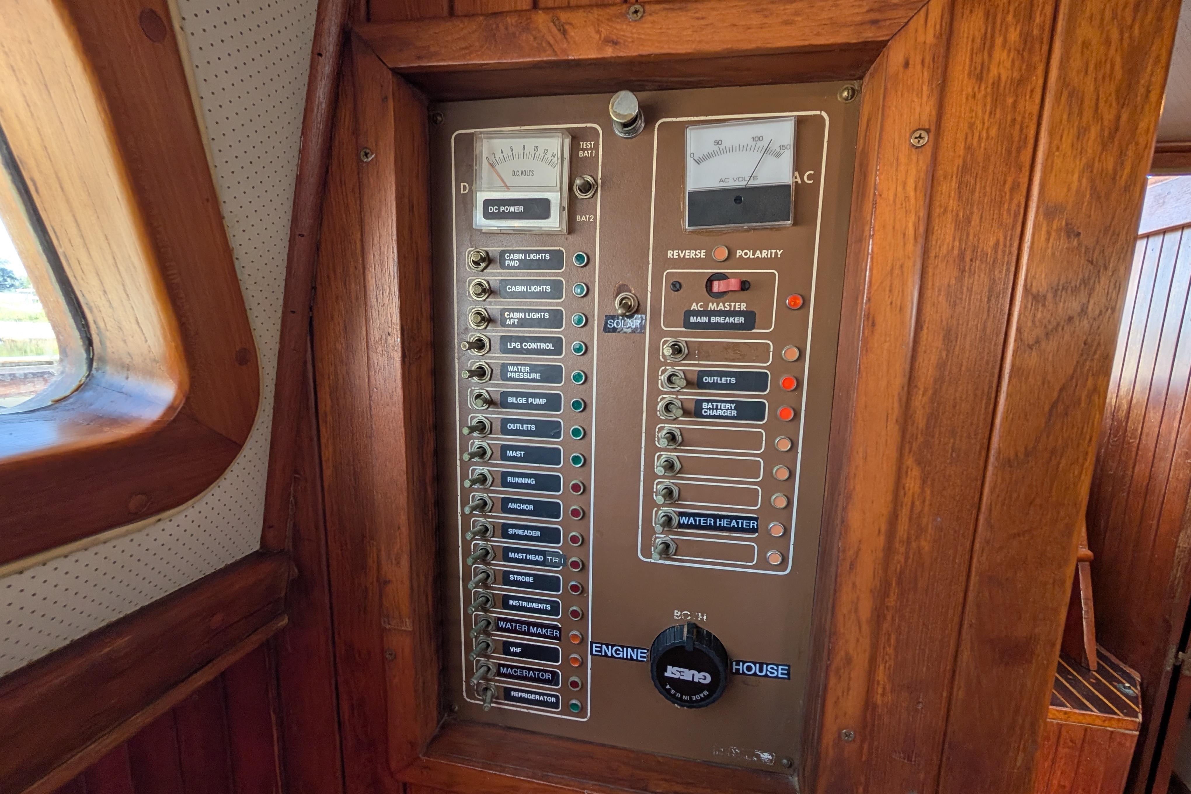 Electrical control panel on a 1983 Robert Perry 41 sailboat, featuring various switches and gauges.