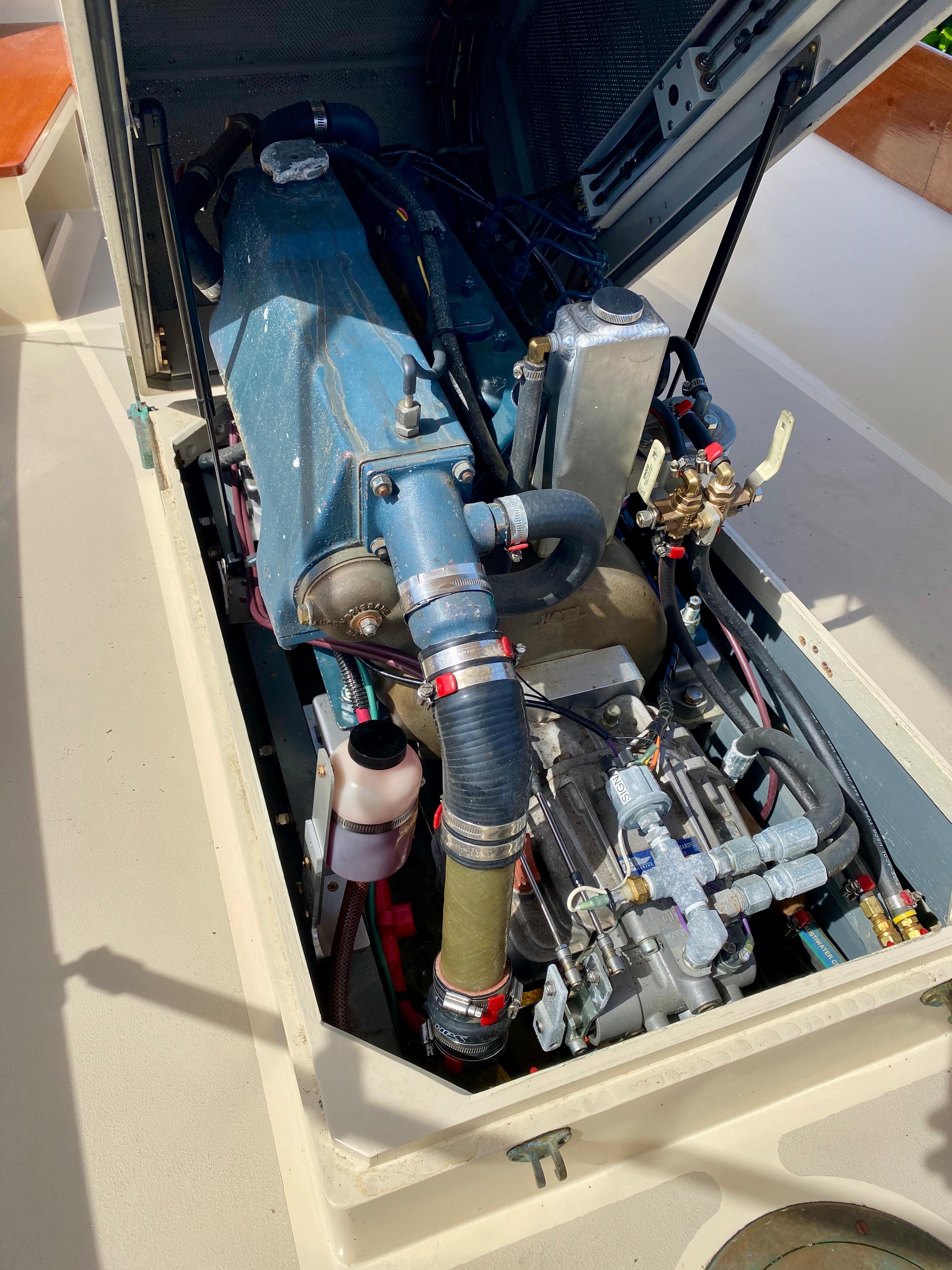 Engine compartment of a 2014 Stimson Ocean Pointer Launch boat, showcasing detailed mechanical components.