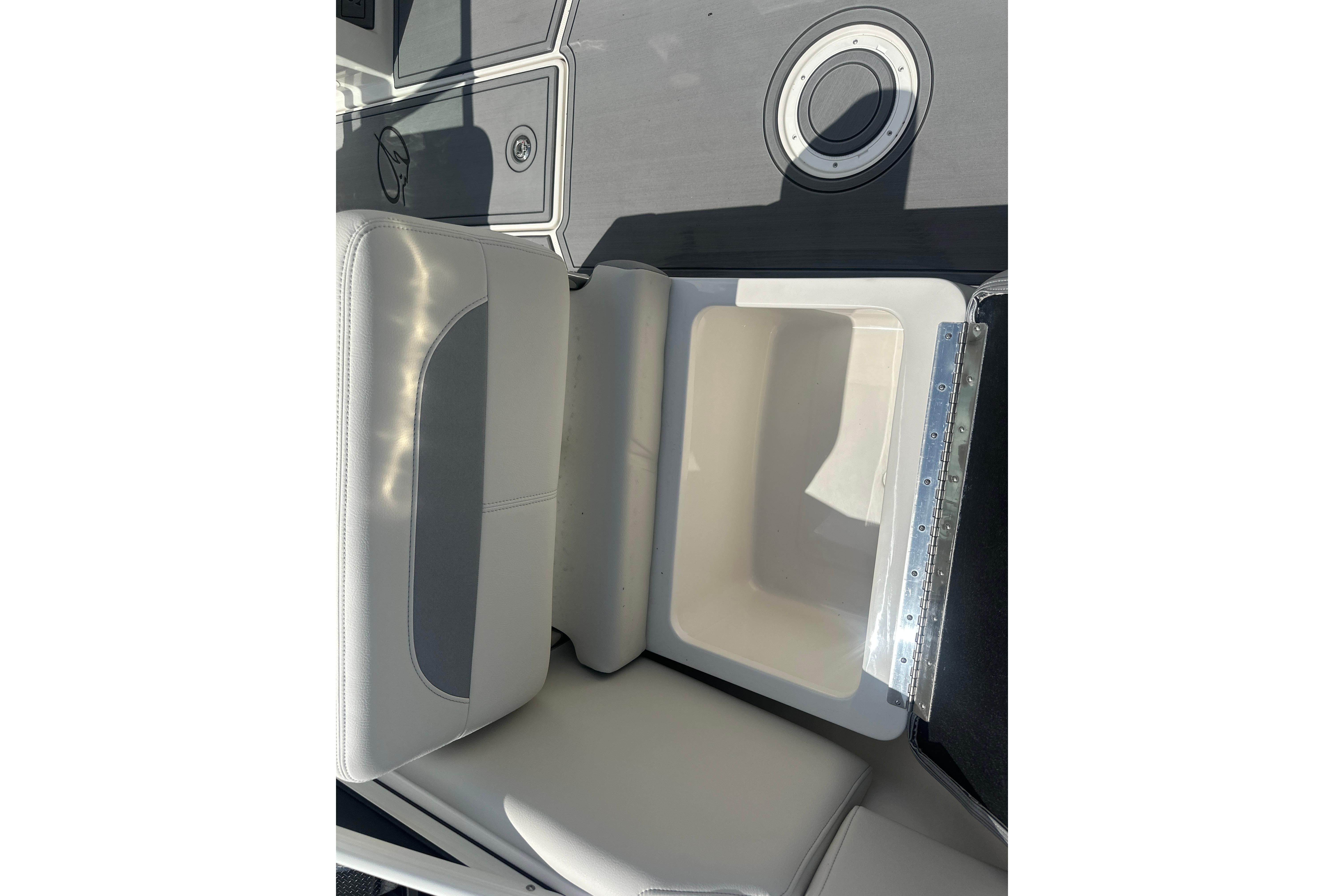 2026 Sailfish 226 DC boat seat with storage compartment open.