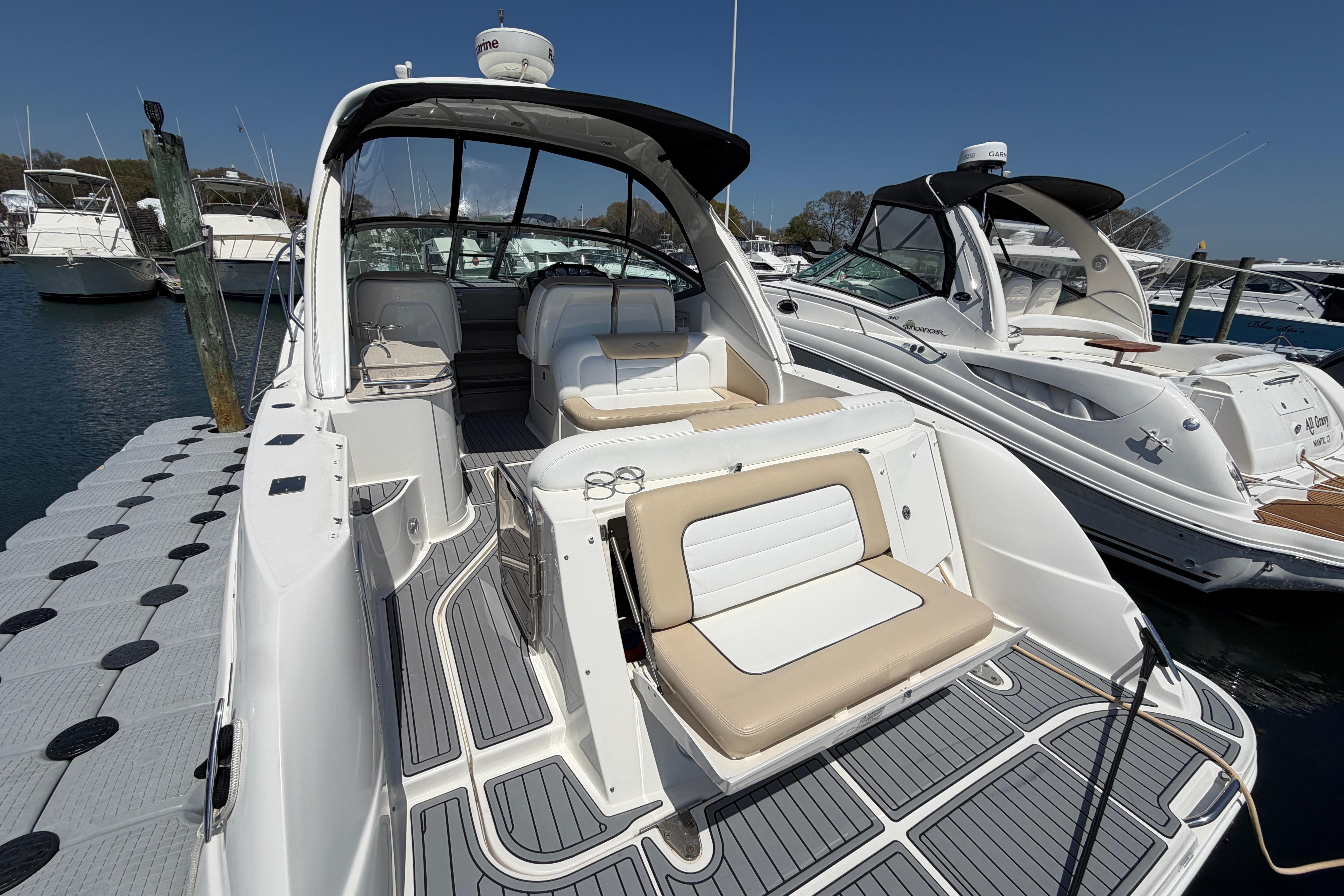 2008 Sea Ray Sundancer 330 docked, showcasing sleek design and spacious seating area.
