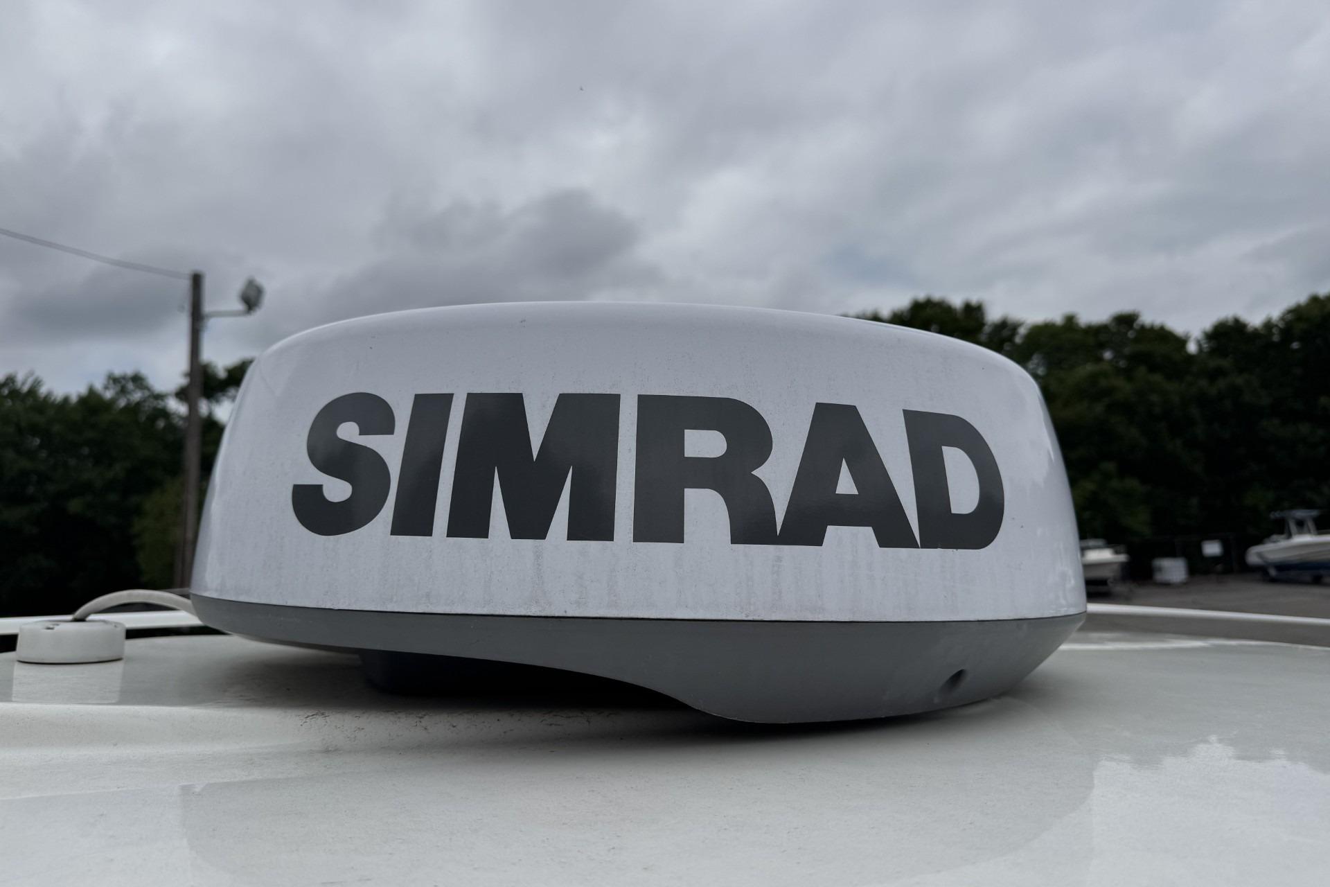 Simrad radar on 2024 Boston Whaler 230 Outrage, cloudy sky background.