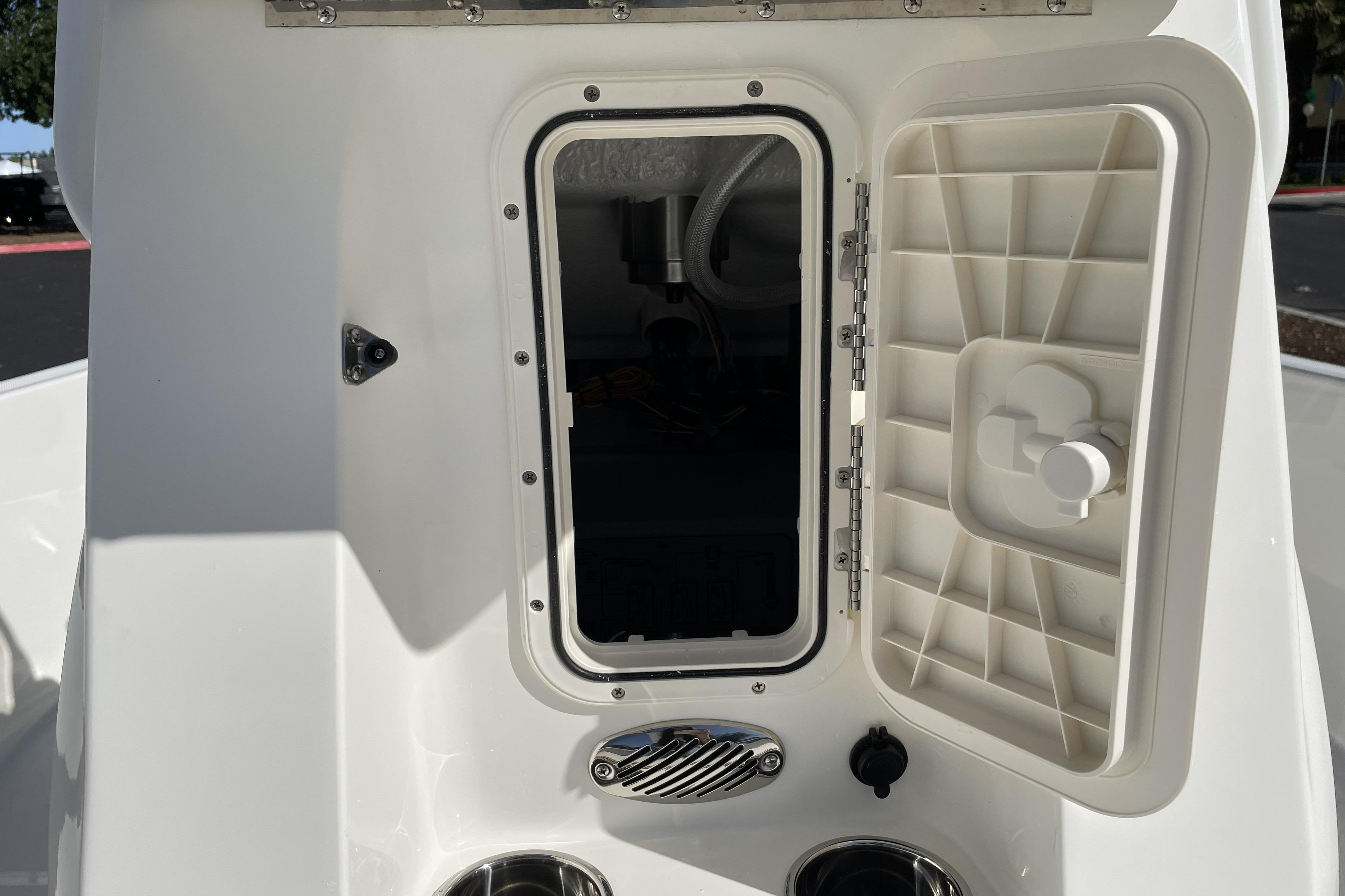 Open storage compartment on a 2026 Mako Pro Skiff 19 CC boat.