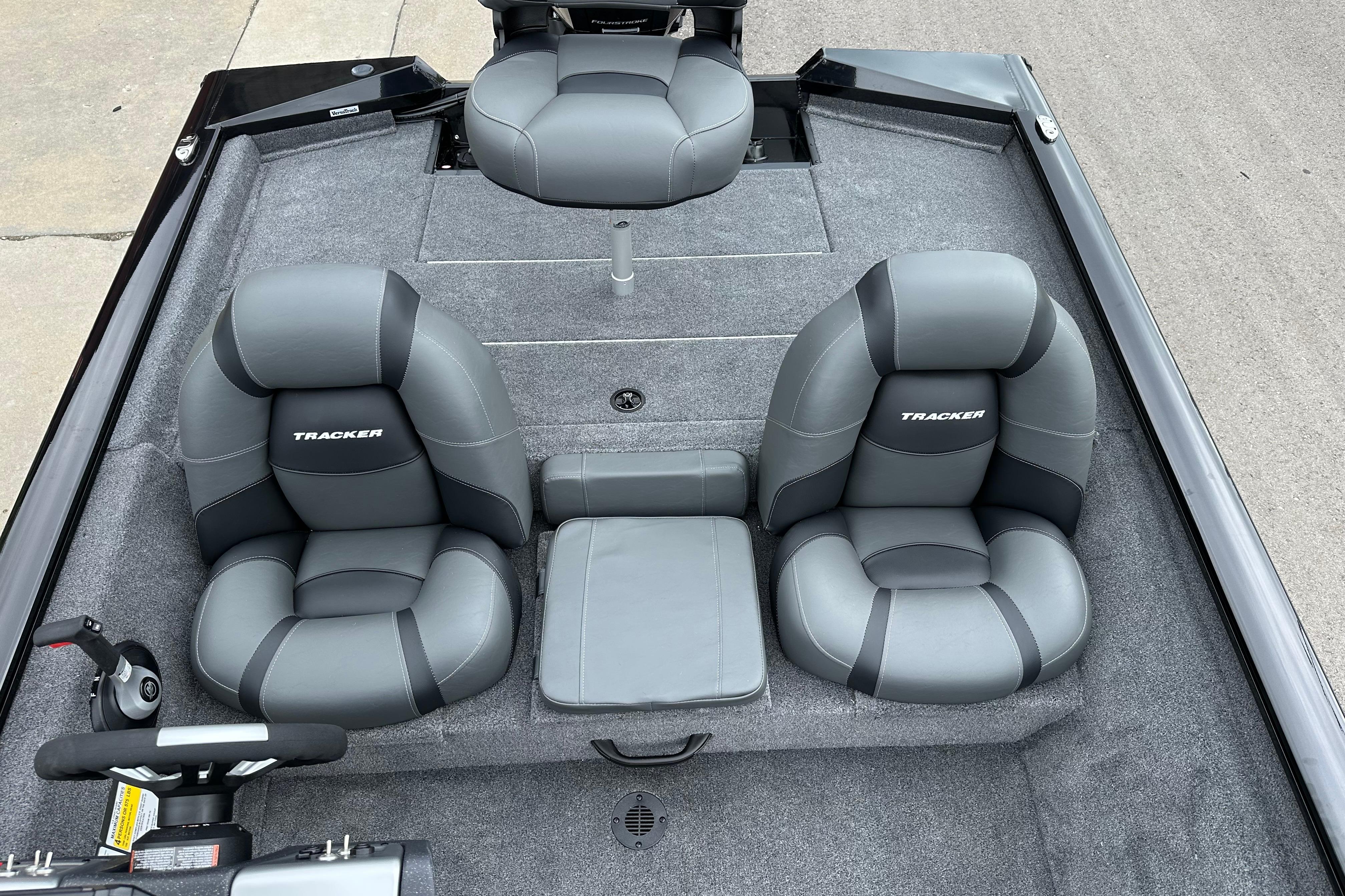 2026 Tracker Pro Team 190 boat interior with gray cushioned seats and steering wheel.