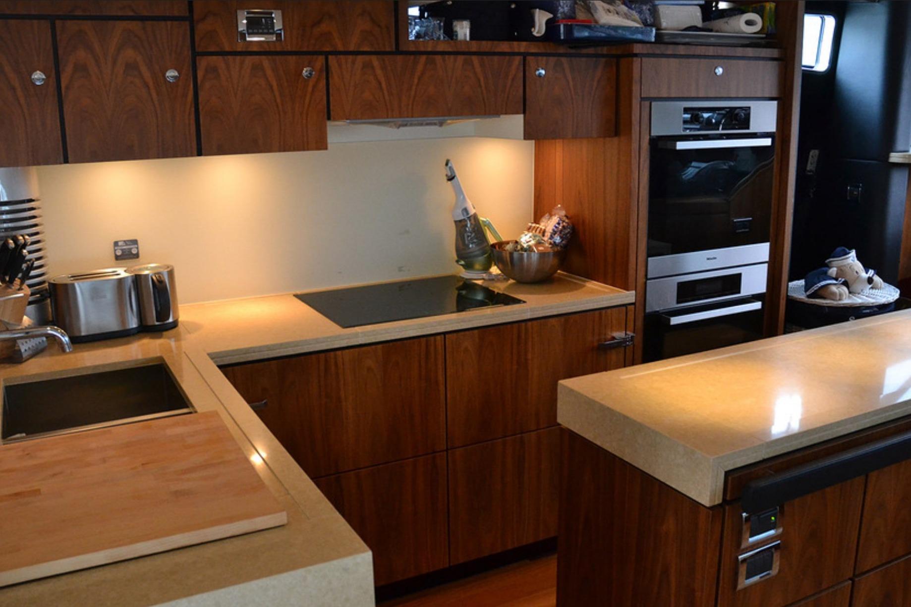 Luxurious kitchen interior of 2012 Fairline Squadron 78 yacht with modern appliances.