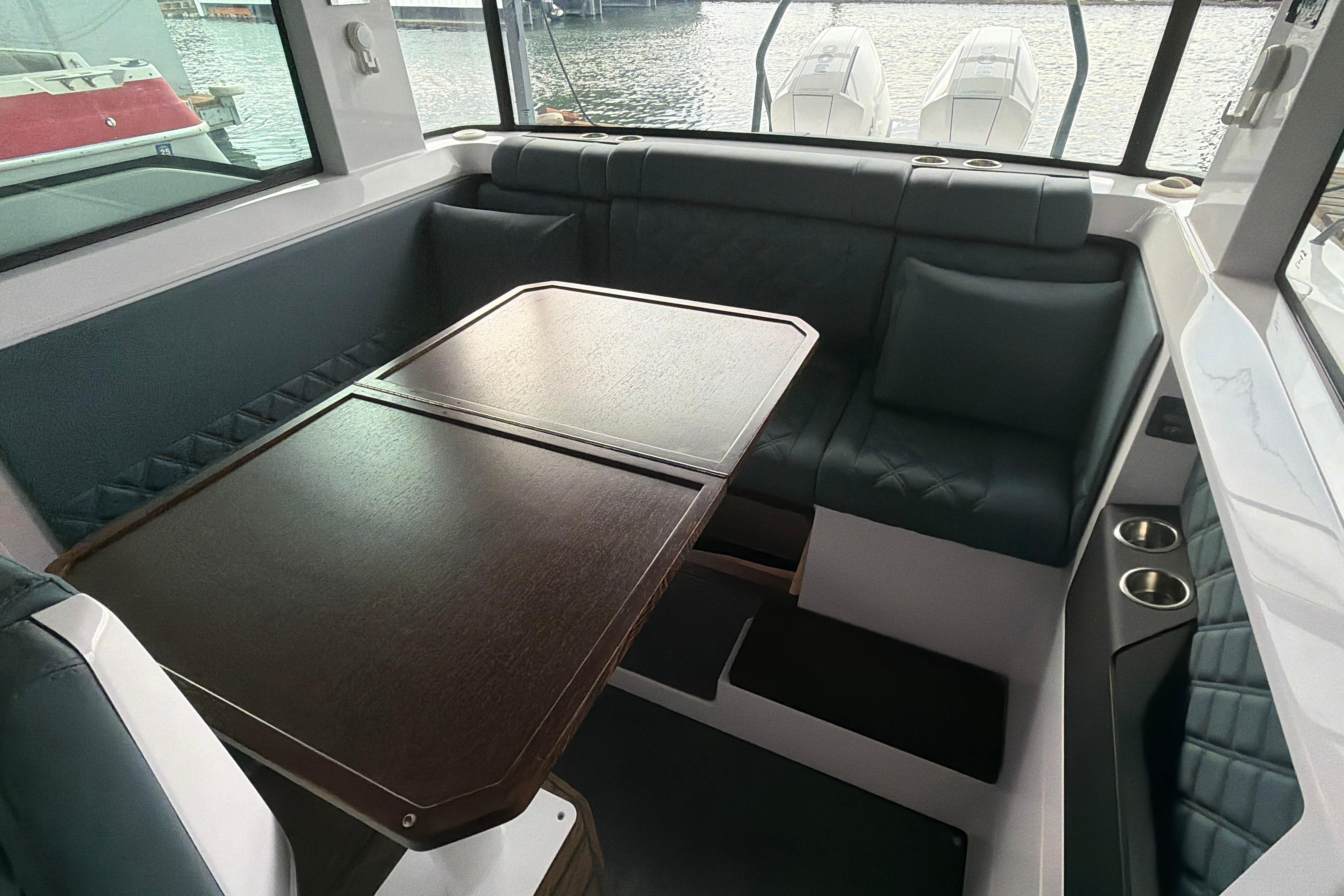 Luxurious interior of 2022 Axopar Brabus 37 XC Cross Cabin with elegant seating and table.