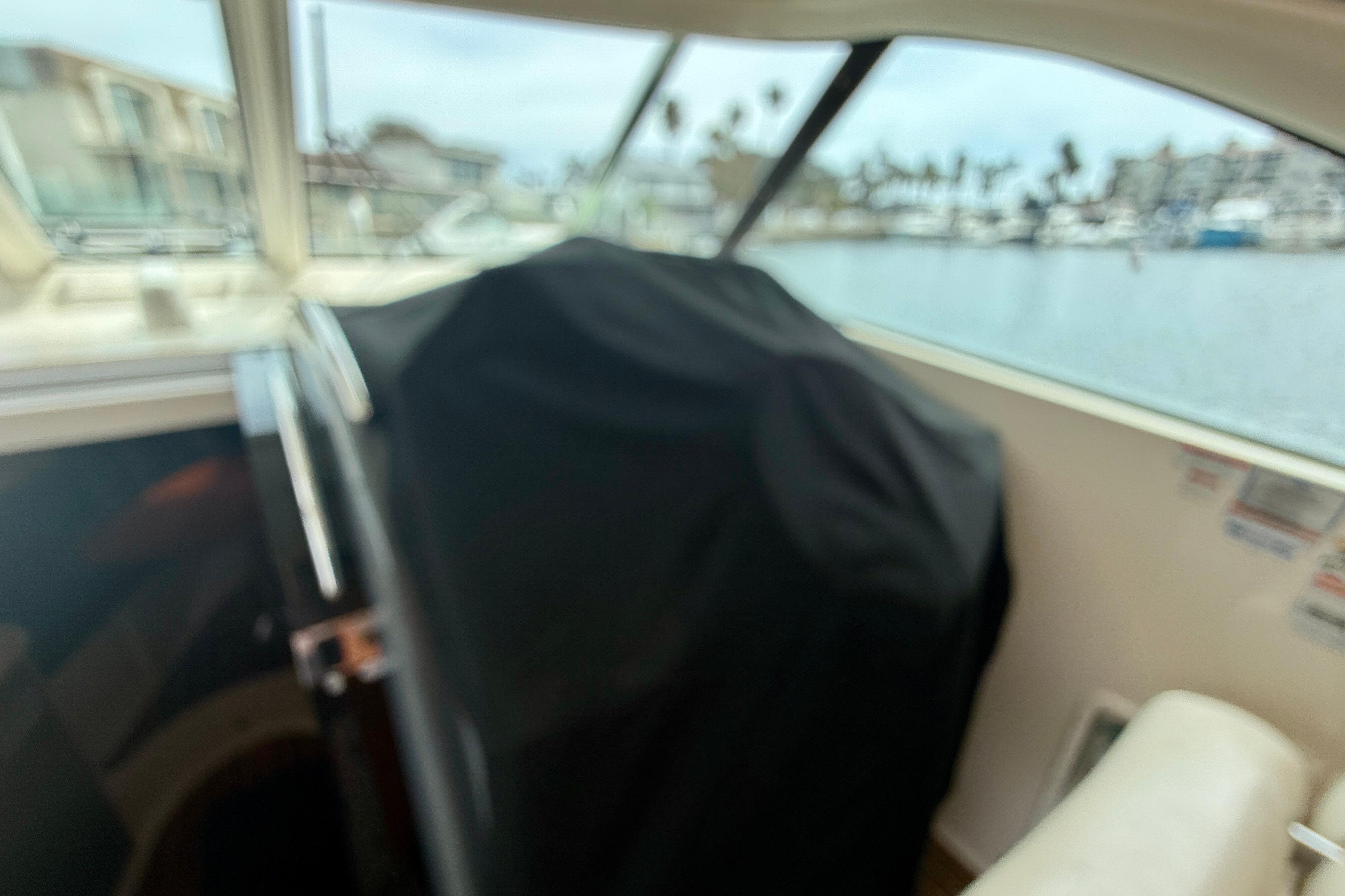 Interior view of a 2012 Pursuit OS 345 Offshore boat with covered equipment.