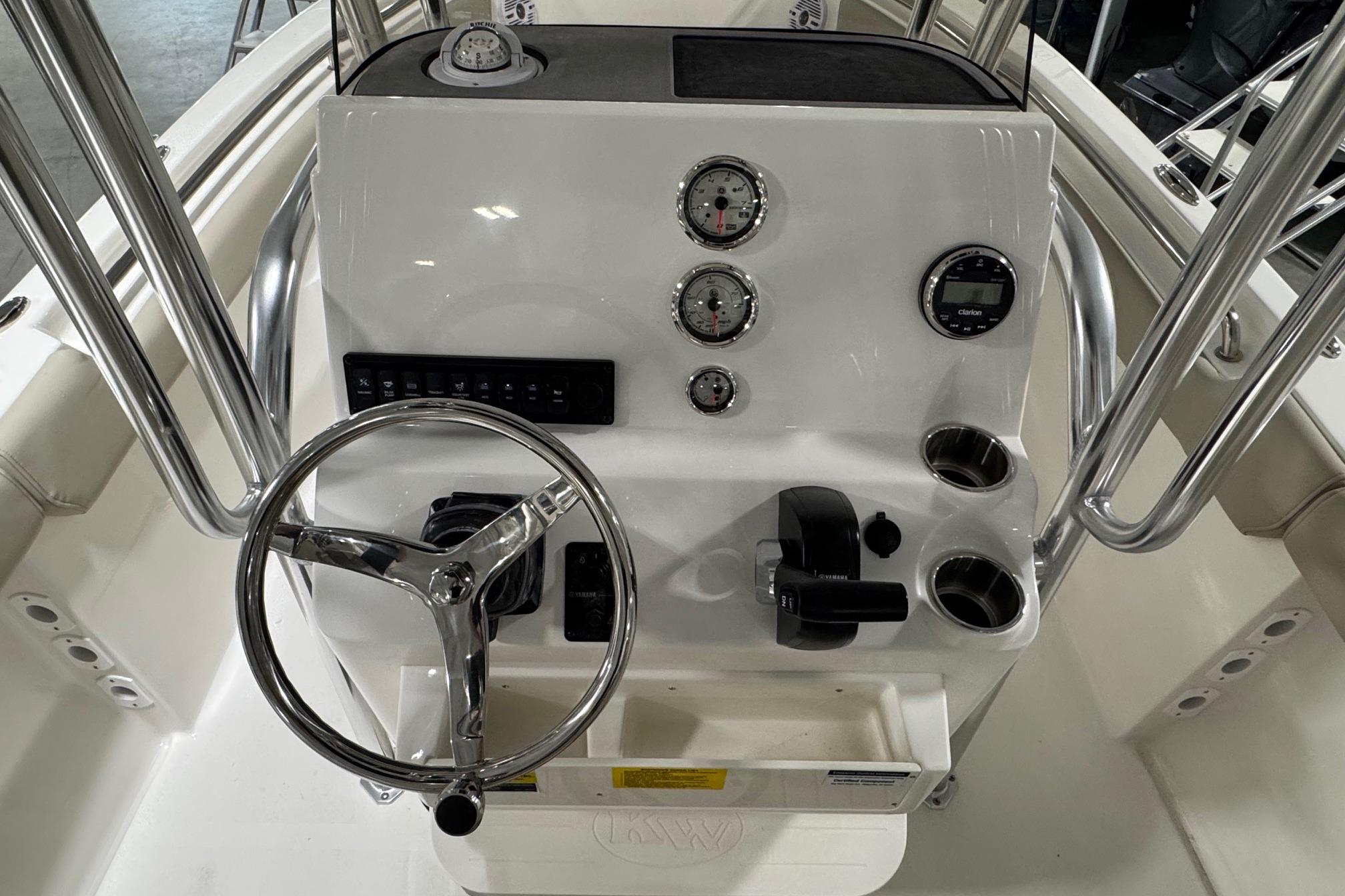 2026 Key West 203 FS boat dashboard with steering wheel and gauges.