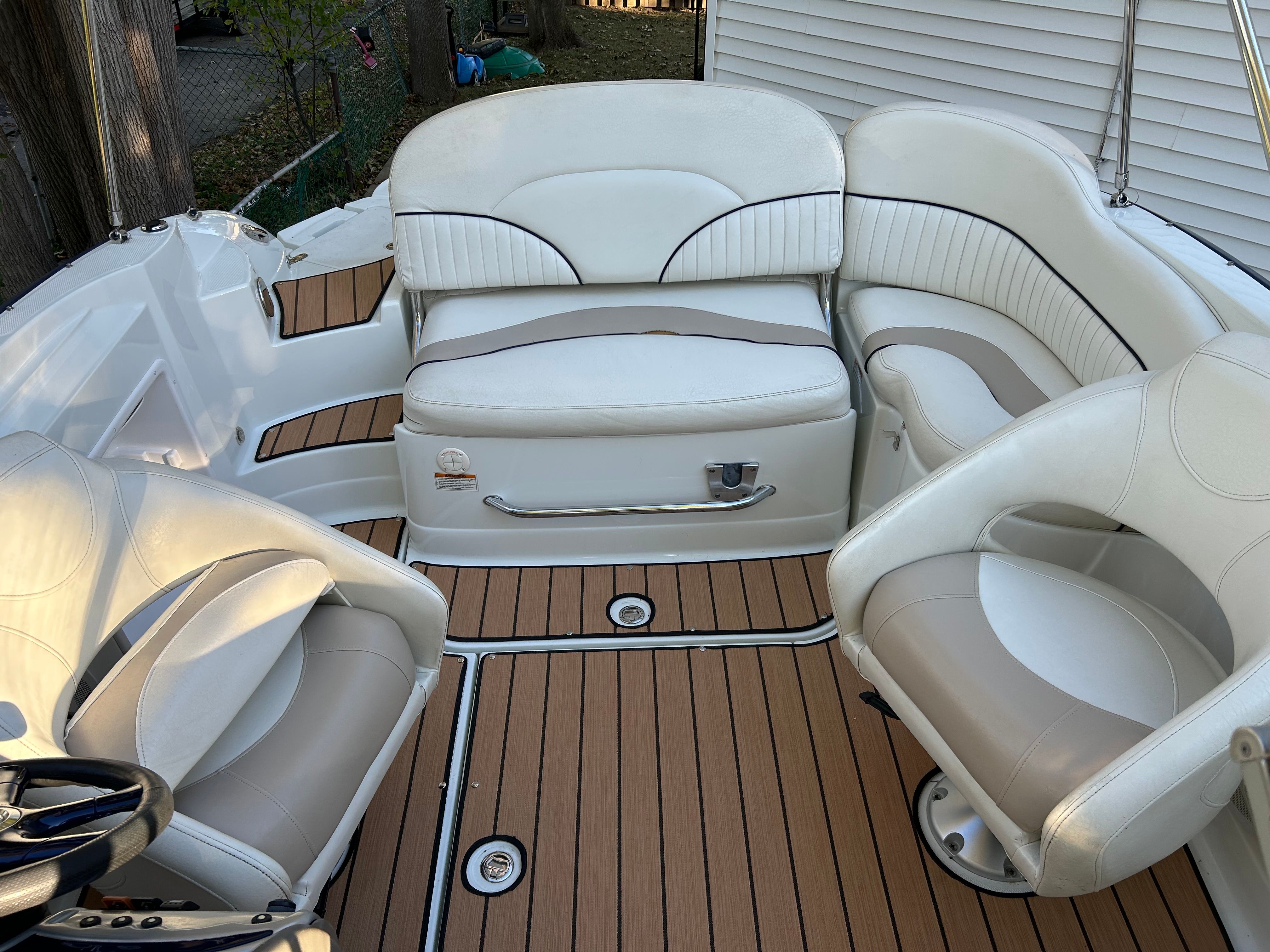 The image shows the cockpit of a 2008 Azure AZ220 boat with white and beige seating.