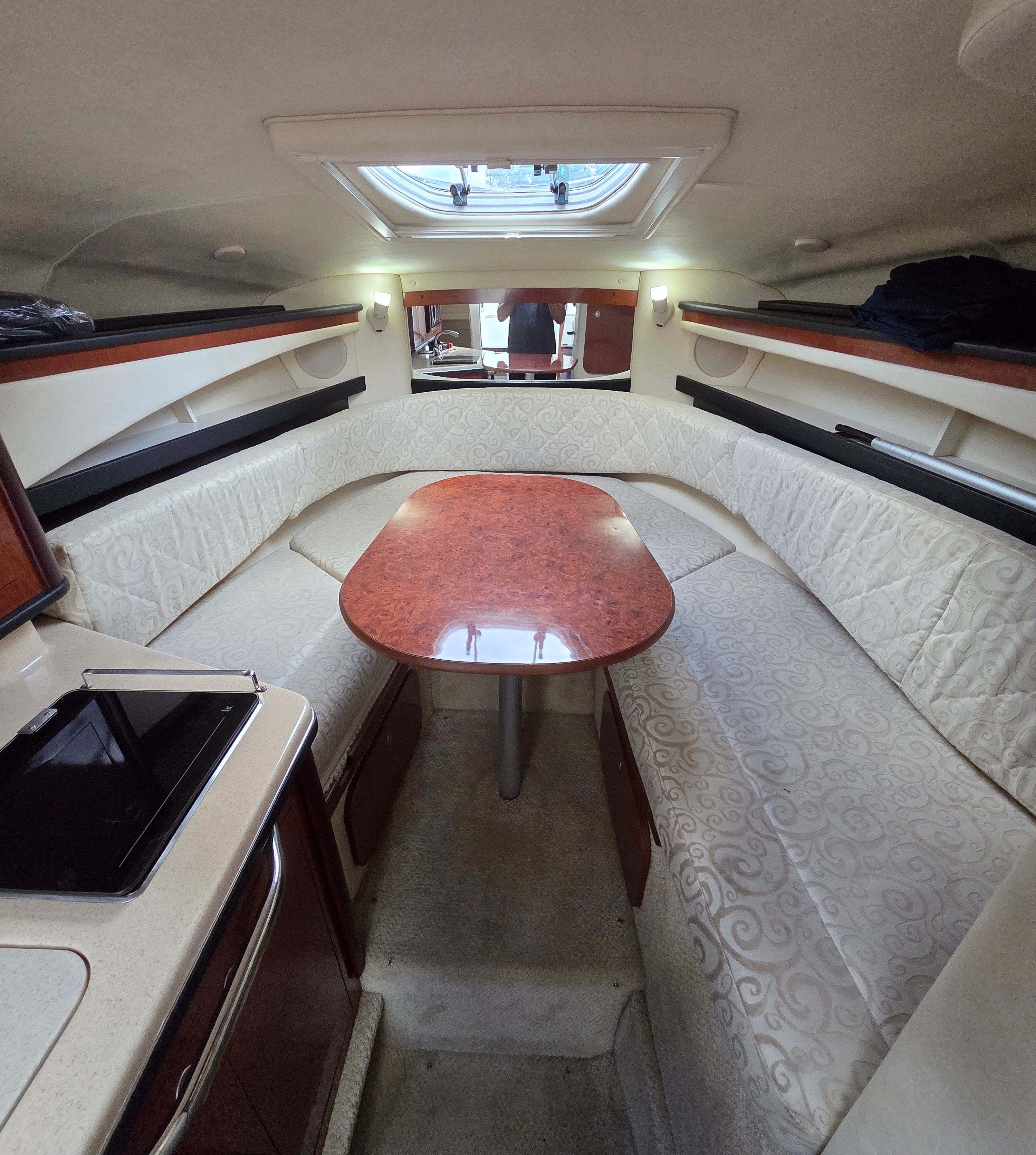 Interior of the 2005 Sea Ray Sundancer 260 with cozy seating area and table.