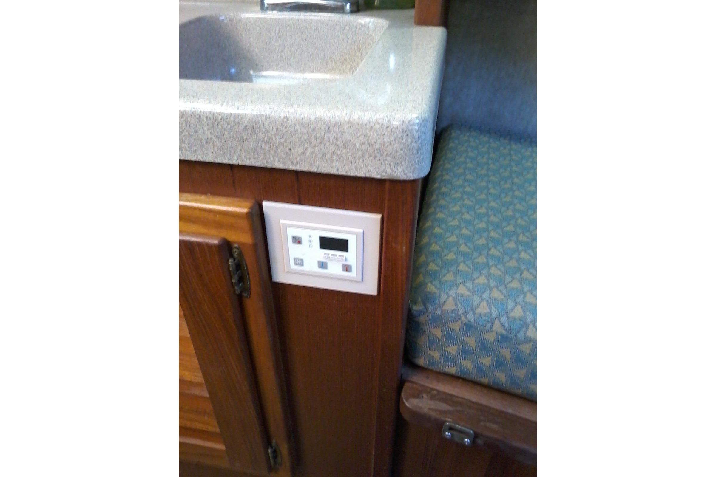 2002 Albemarle 265 Express Fisherman cabin interior with sink and control panel.