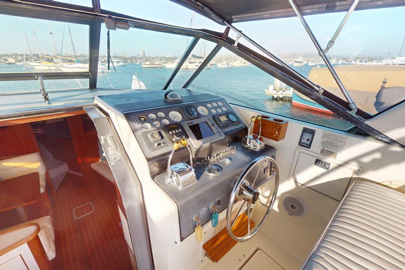 Cockpit of 1989 Tiara 3300 Open yacht with steering wheel and control panel.