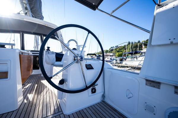 Steering wheel of a 2021 Beneteau Oceanis 38.1 yacht in harbor.