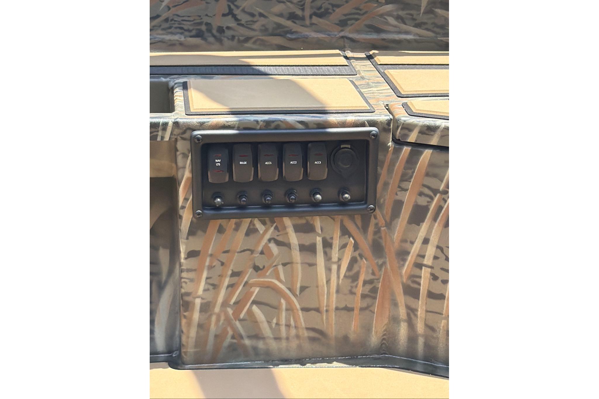 Control panel of 2026 Tracker Grizzly 1756 T Marsh boat with camouflage design.