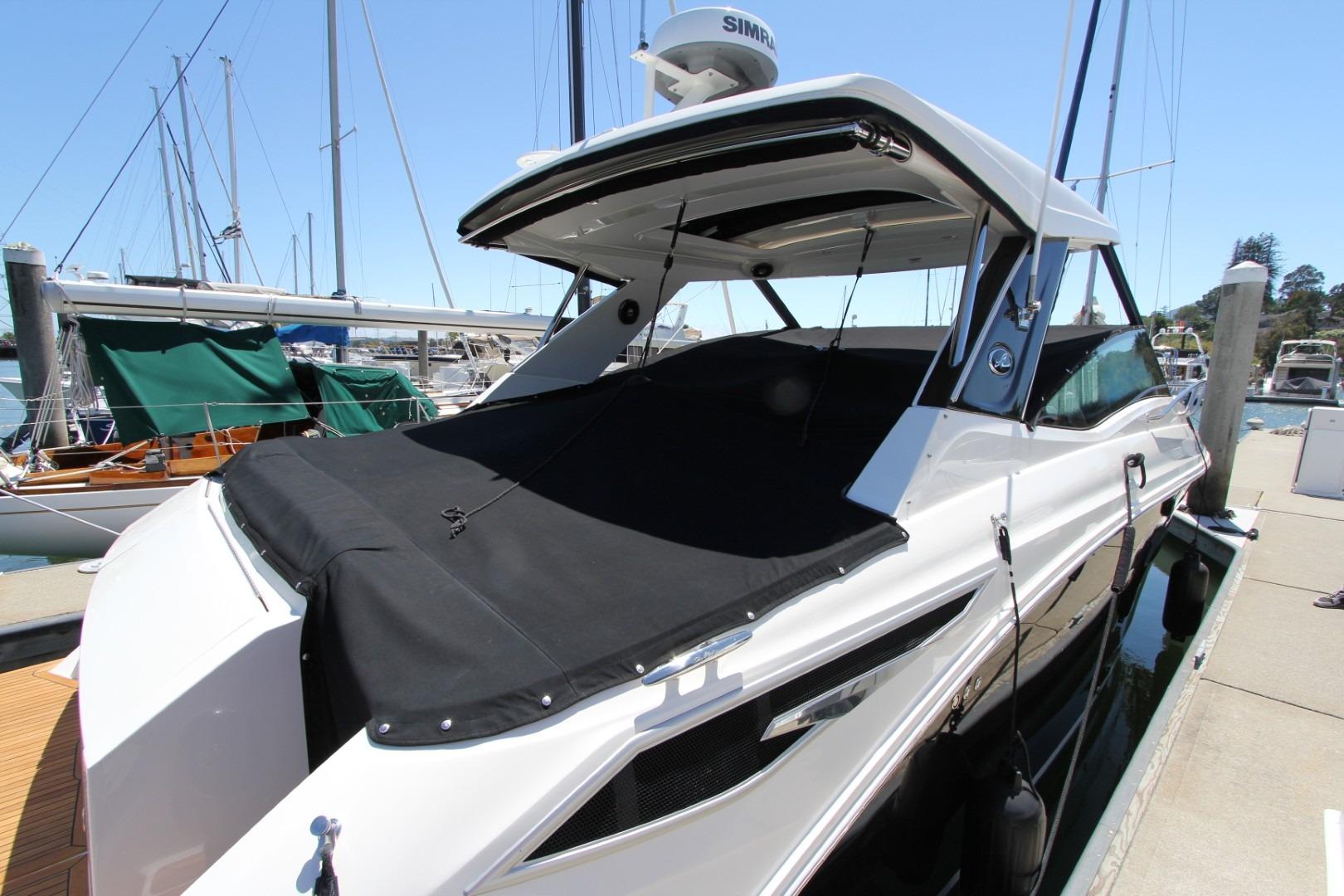2021 Sea Ray Sundancer 320 Outboard docked at marina, featuring sleek design and black cover.