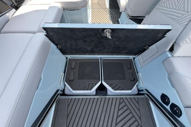 2026 MasterCraft XStar 25 boat interior storage compartment with open lid and seating.