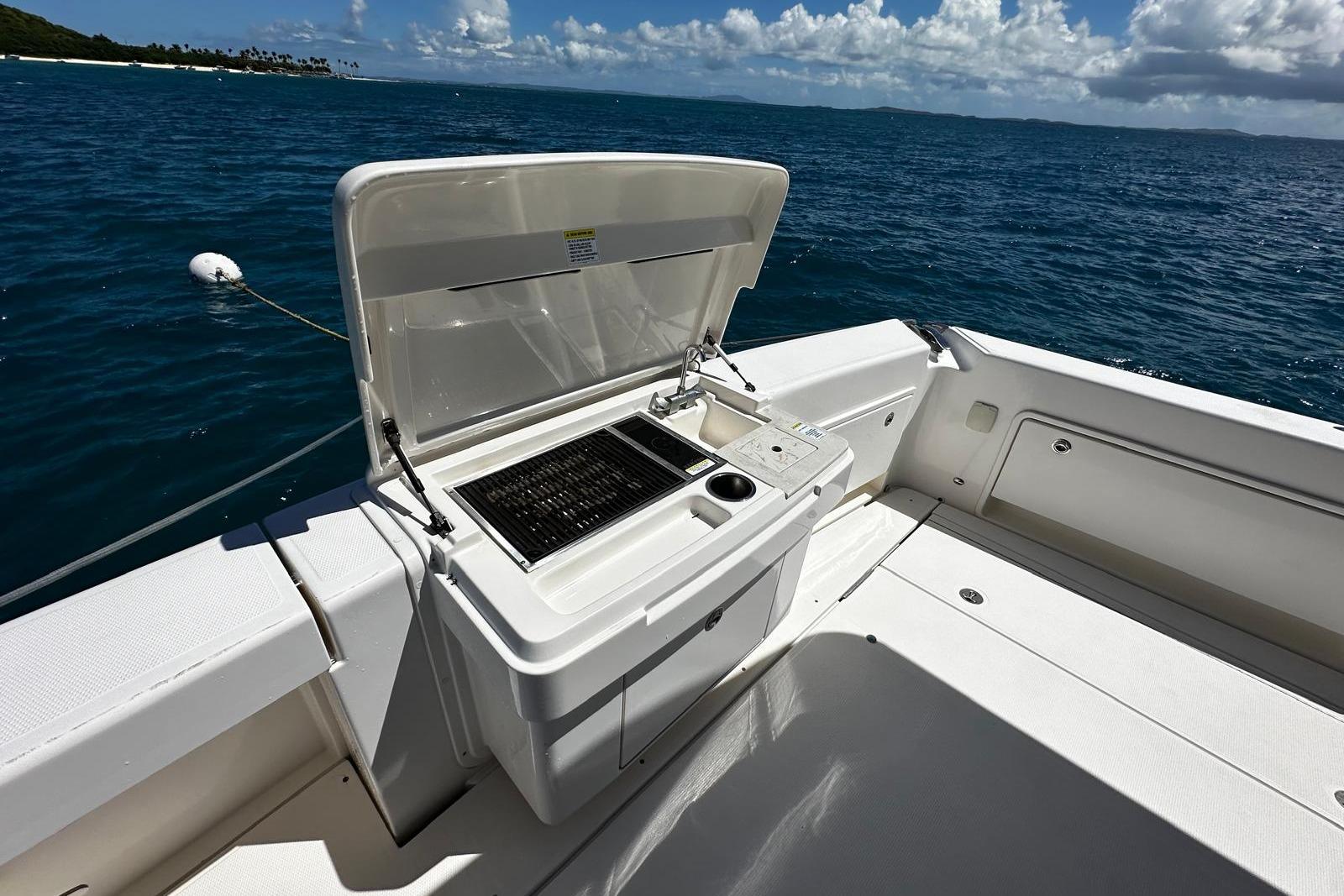 Outdoor grill on 2012 Riviera 43 Flybridge yacht, ocean view in background.