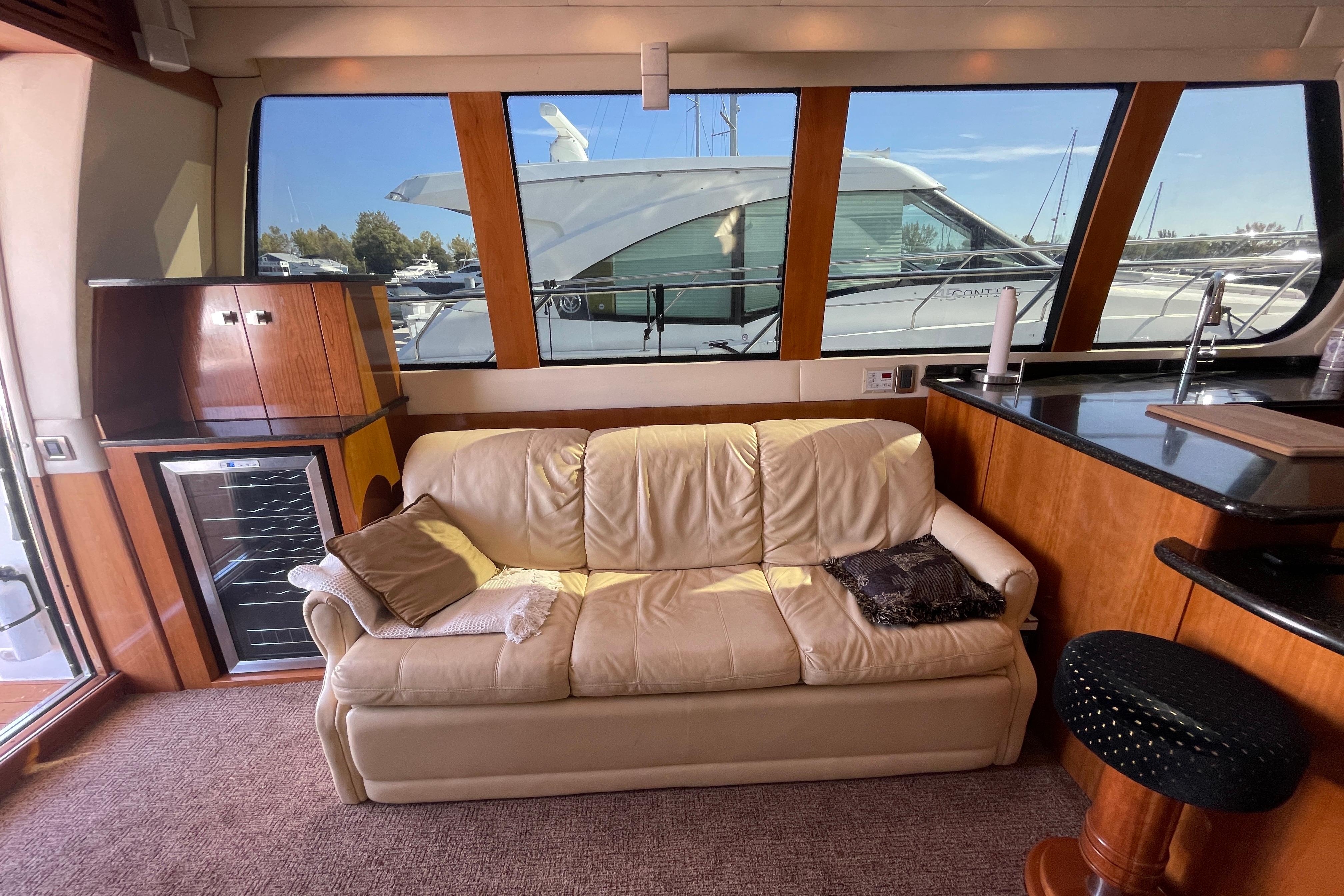 Luxurious interior of 2002 Carver 570 Voyager Pilothouse with leather sofa and kitchenette.