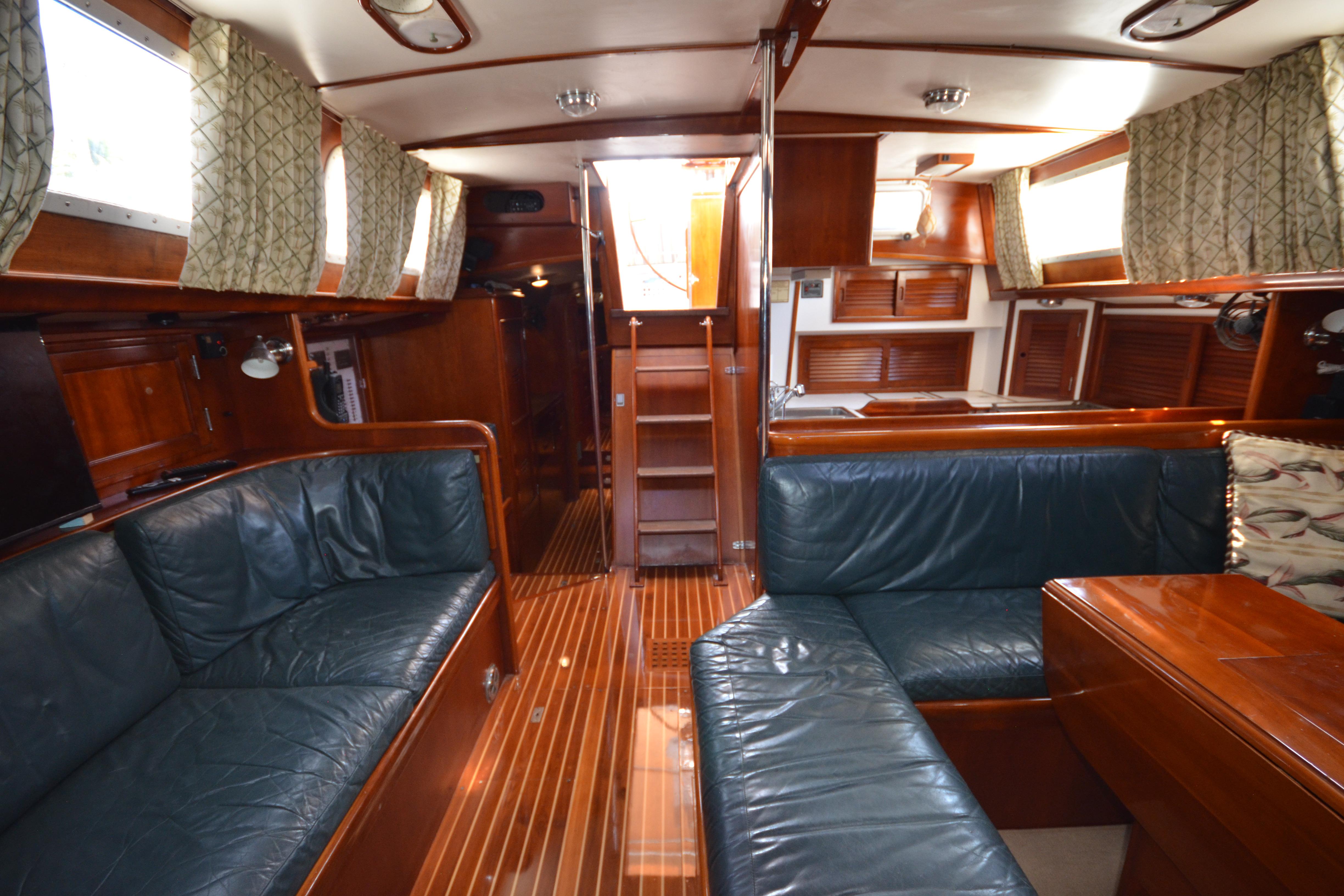 Luxurious interior of a 1992 Hinckley Sou'wester 59 yacht with elegant wood finishes.